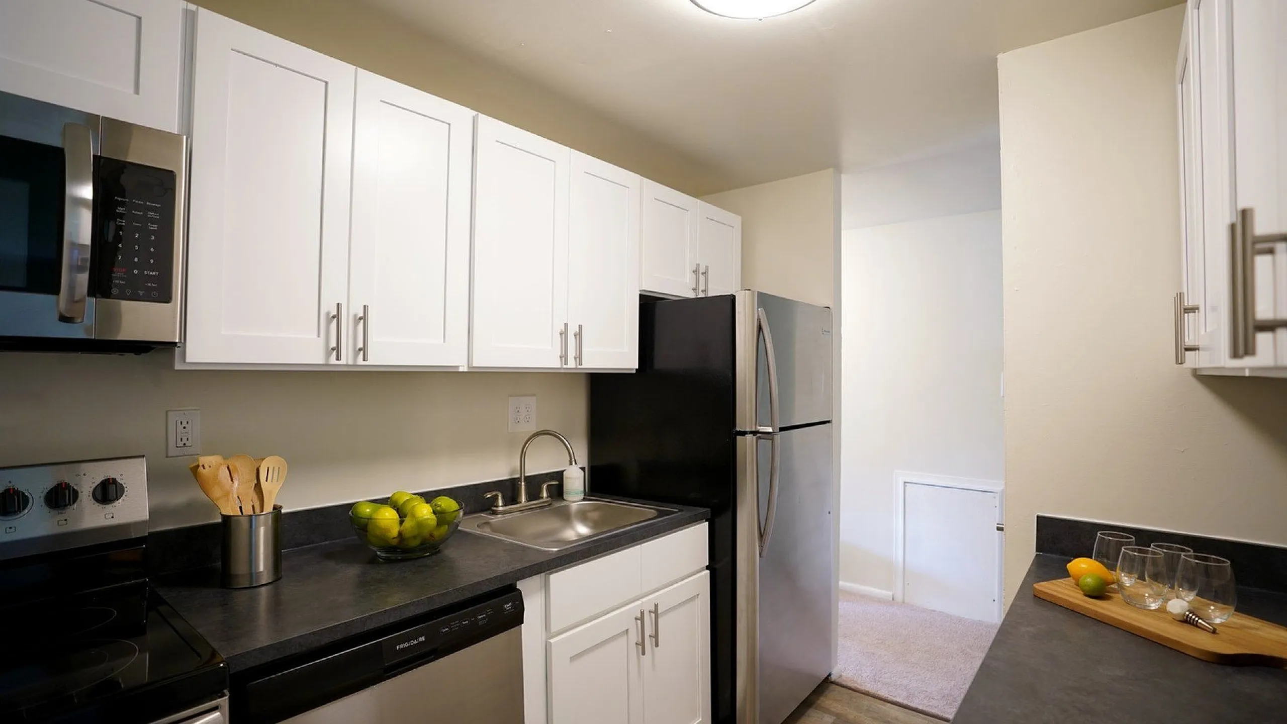 Modern kitchen with sleek stainless steel appliances, white cabinetry, and elegant countertops, perfect for culinary creativity.