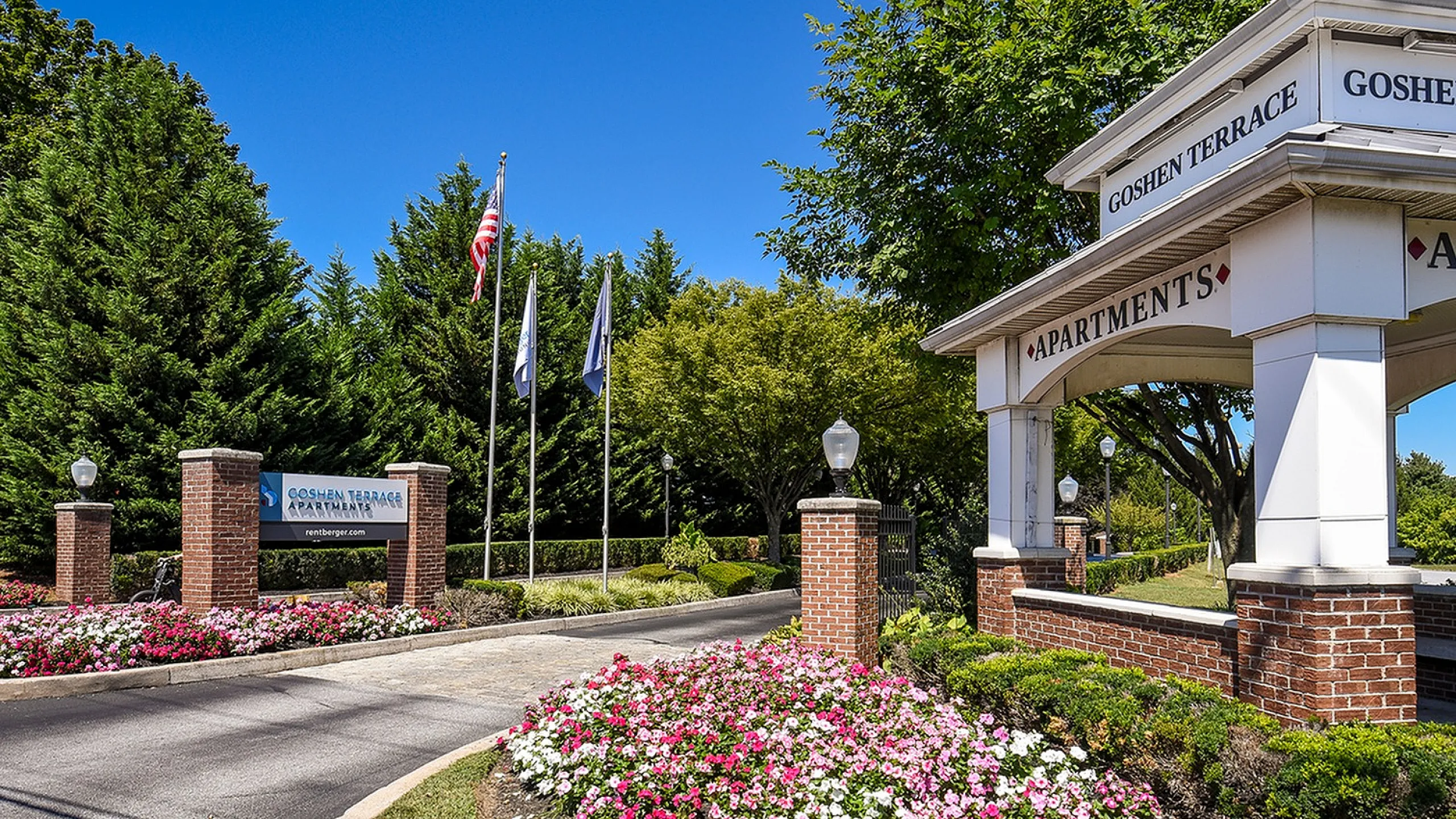 Charming Goshen Terrace entrance with elegant signage, manicured gardens, and welcoming curb appeal.