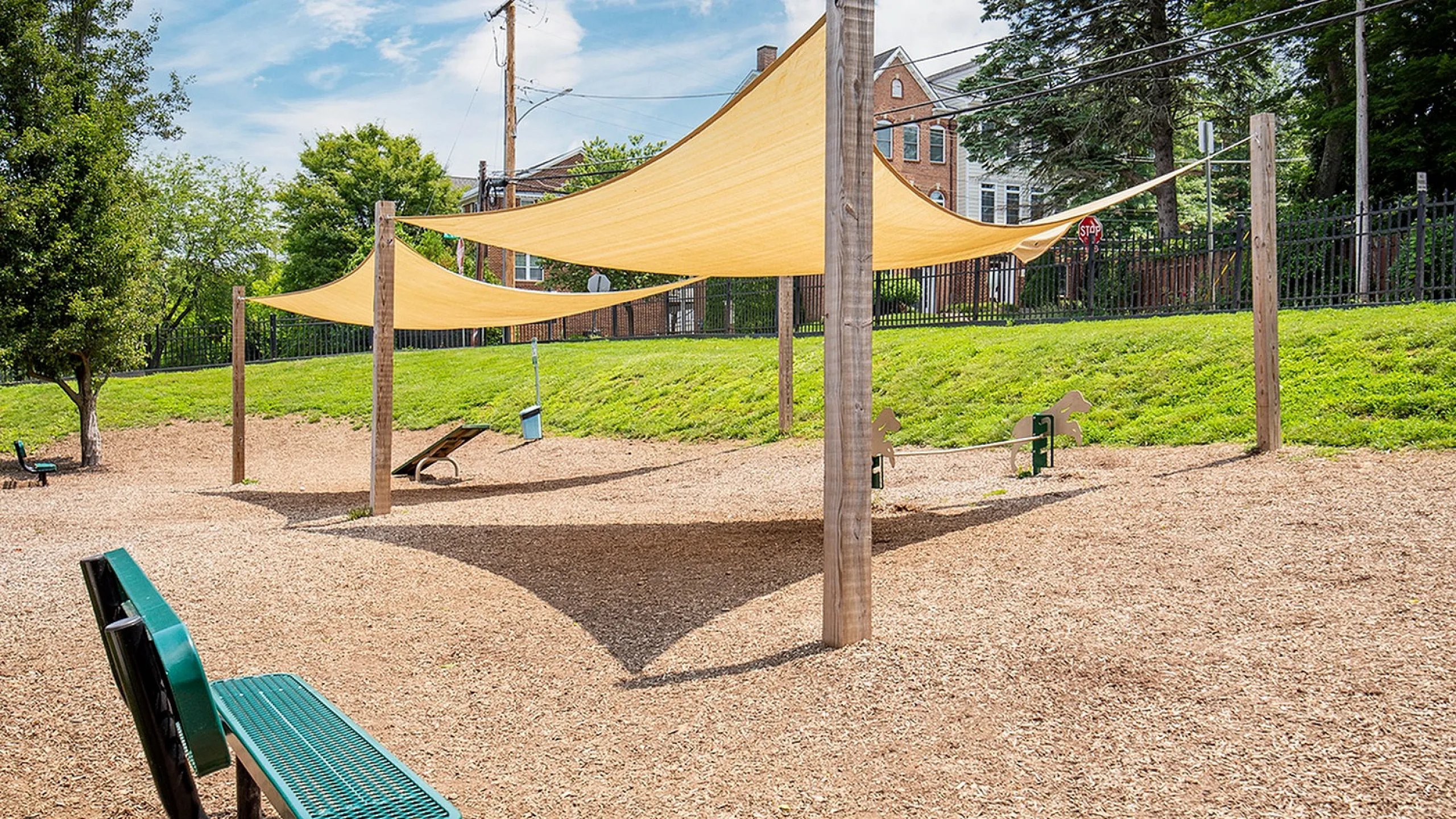 Charming outdoor play area with modern shade canopies, perfect for family fun and relaxation.