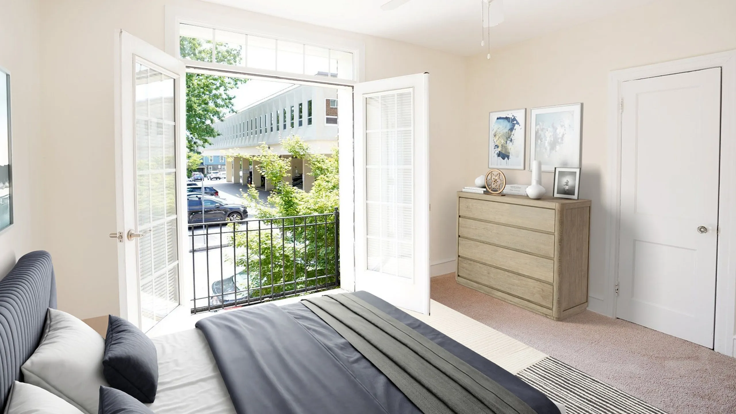 Bright and airy bedroom featuring elegant double doors opening to a charming balcony, perfect for enjoying fresh air and city views.