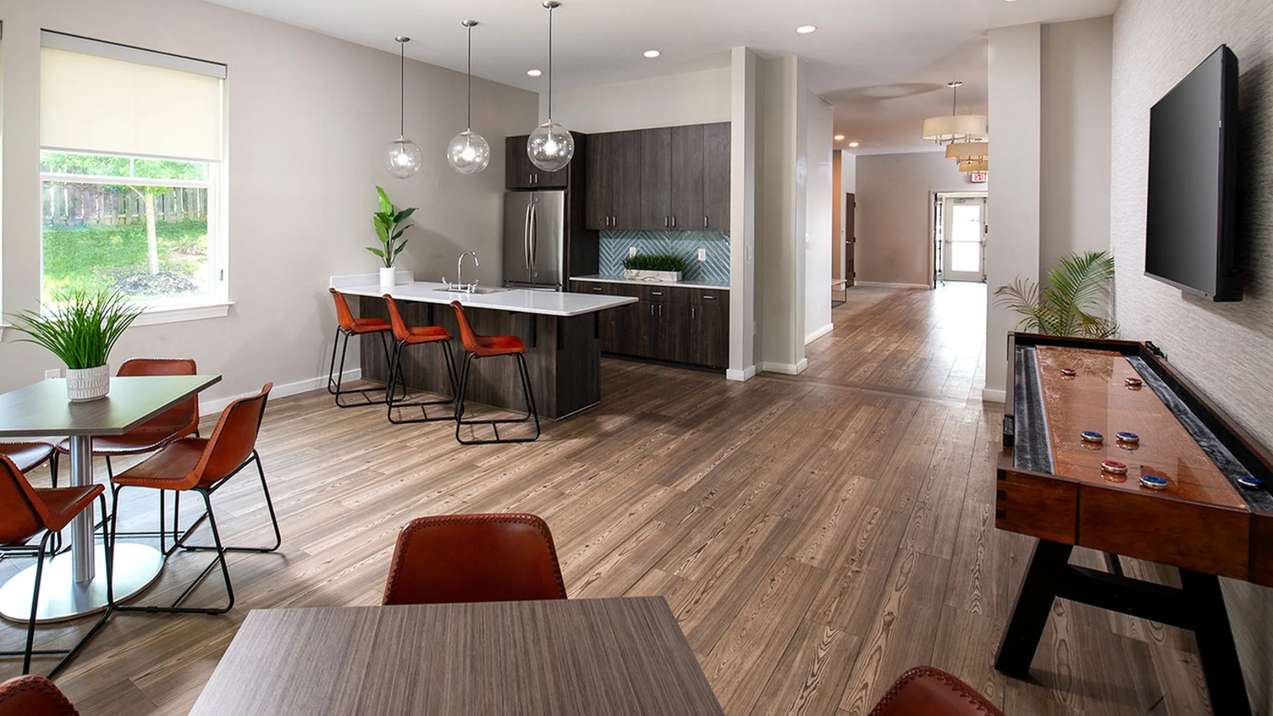 Charming brick apartment building with lush greenery and a welcoming entrance, perfect for relaxed suburban living.