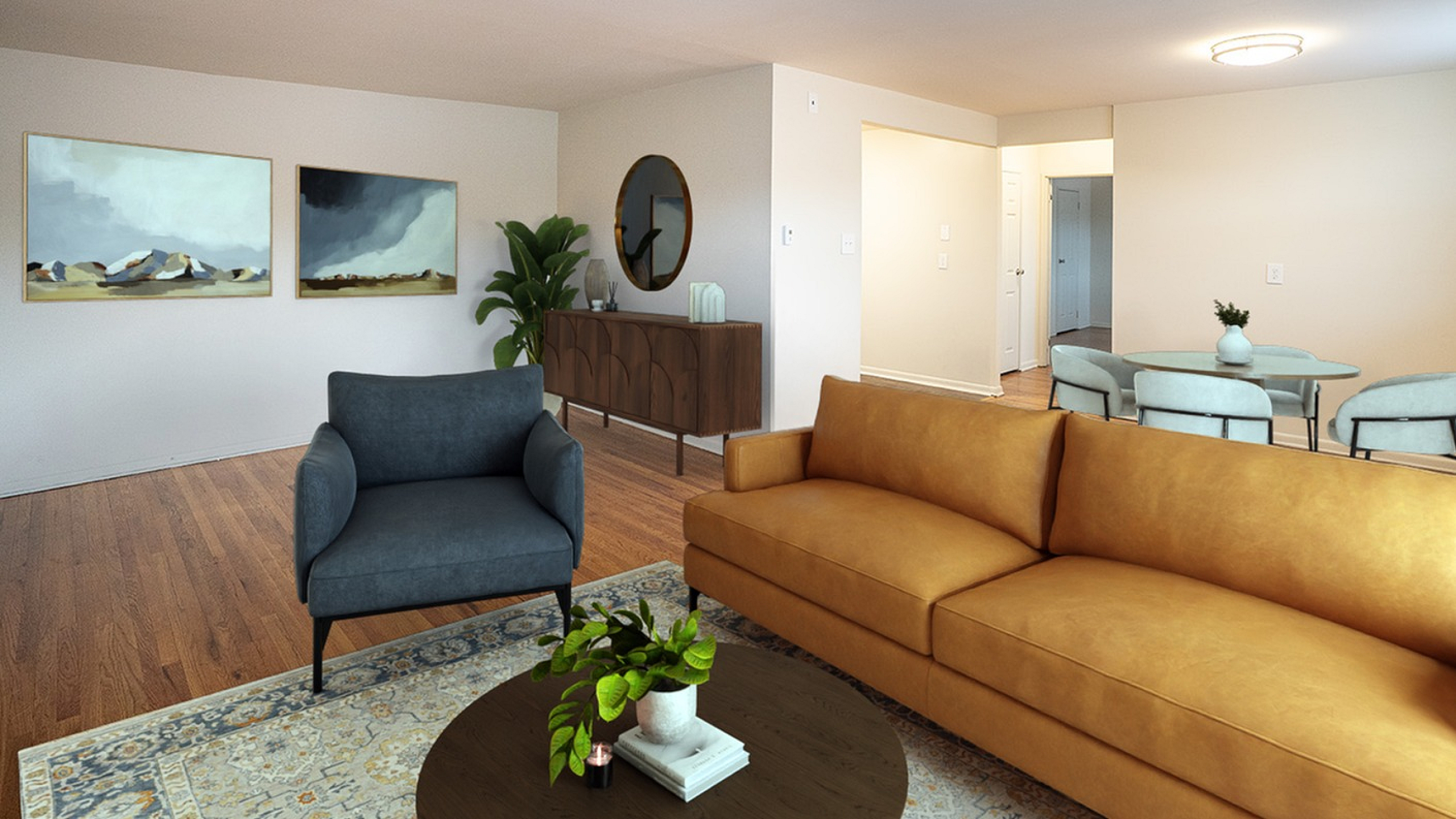 Elegant living room with a warm, inviting design showcasing a plush yellow sofa, chic blue armchair, modern art, and sleek dining area.