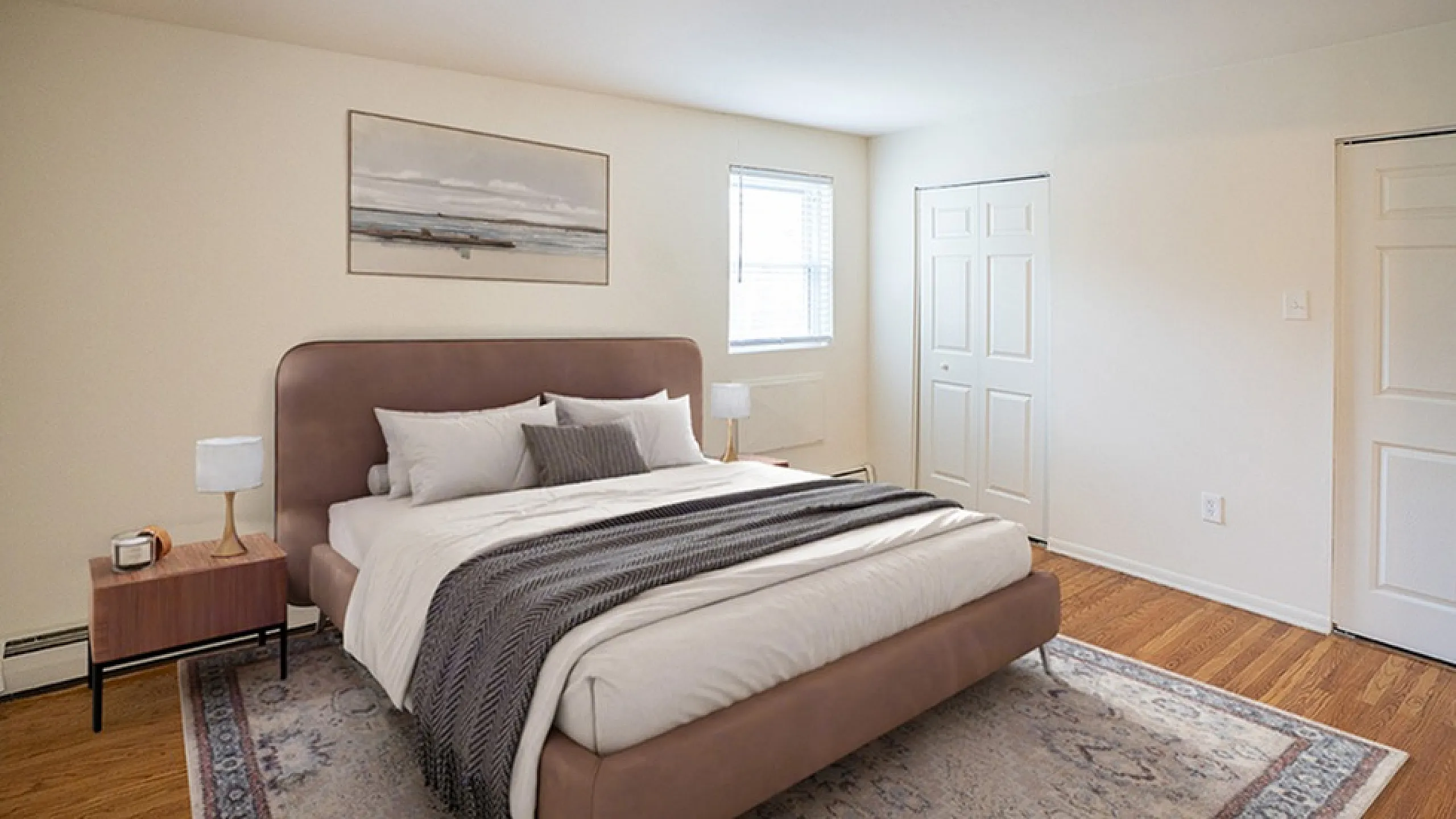 Inviting bedroom with elegant queen-sized bed, warm wooden floors, and cozy natural light.