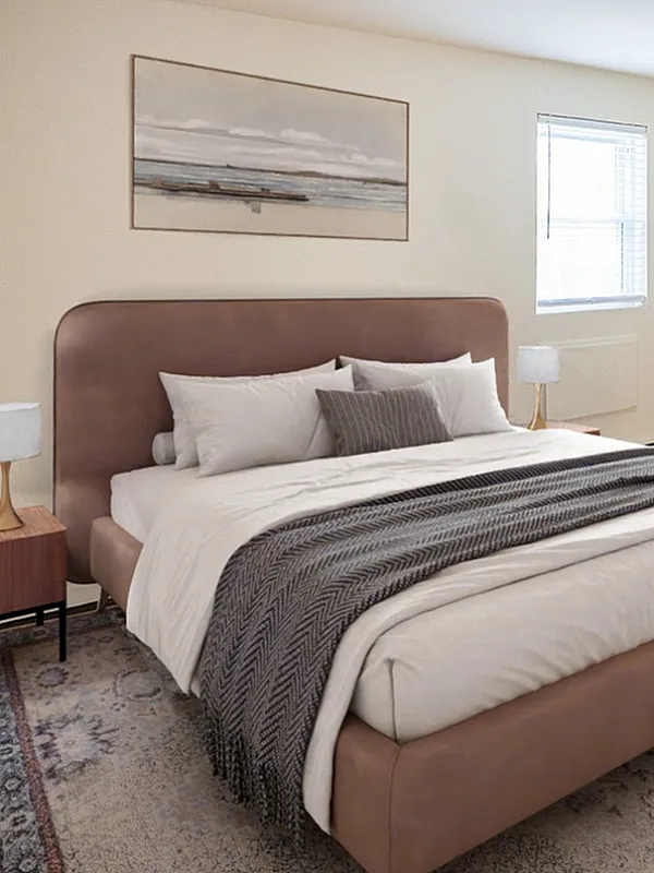 Inviting bedroom with a plush king-sized bed, elegant wooden flooring, and natural light creating a serene atmosphere.