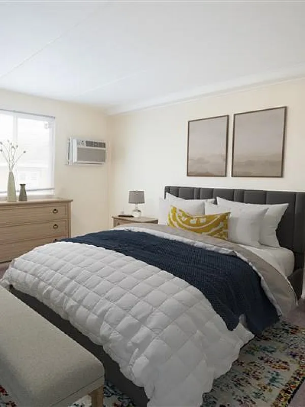 Inviting bedroom with elegant d&eacute;cor, featuring a cozy bed, chic artwork, and natural light.