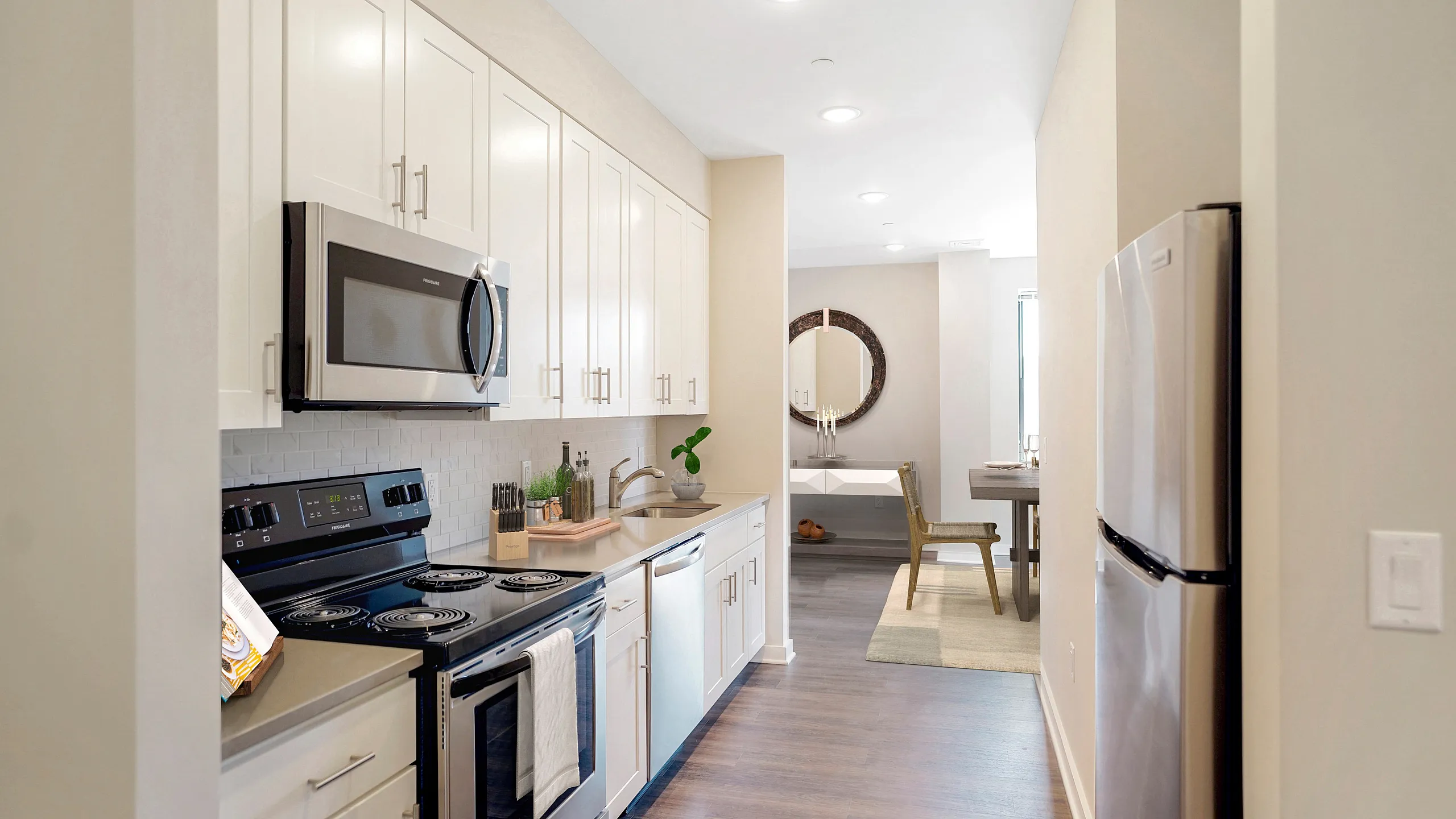 Chic kitchen with modern appliances, sleek cabinetry, and open flow into a stylish dining area.