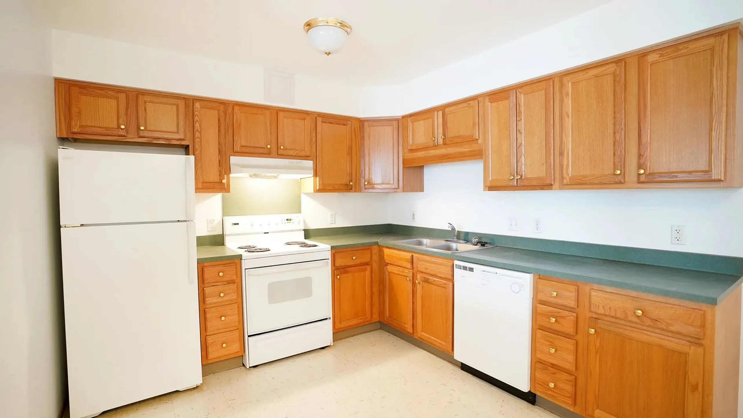 Bright and inviting kitchen with oak cabinets, modern appliances, and ample counter space.