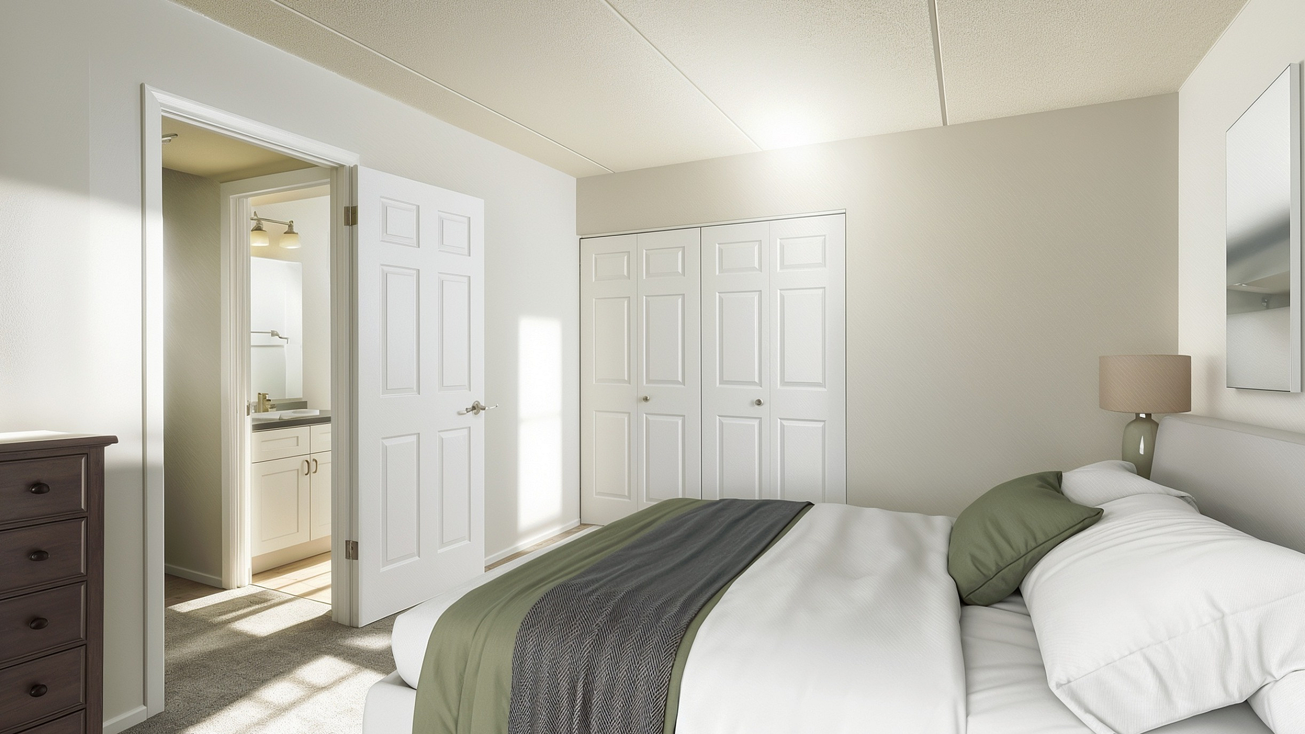 Elegant bedroom with soft lighting, plush bedding, ample storage, and en-suite bathroom view.