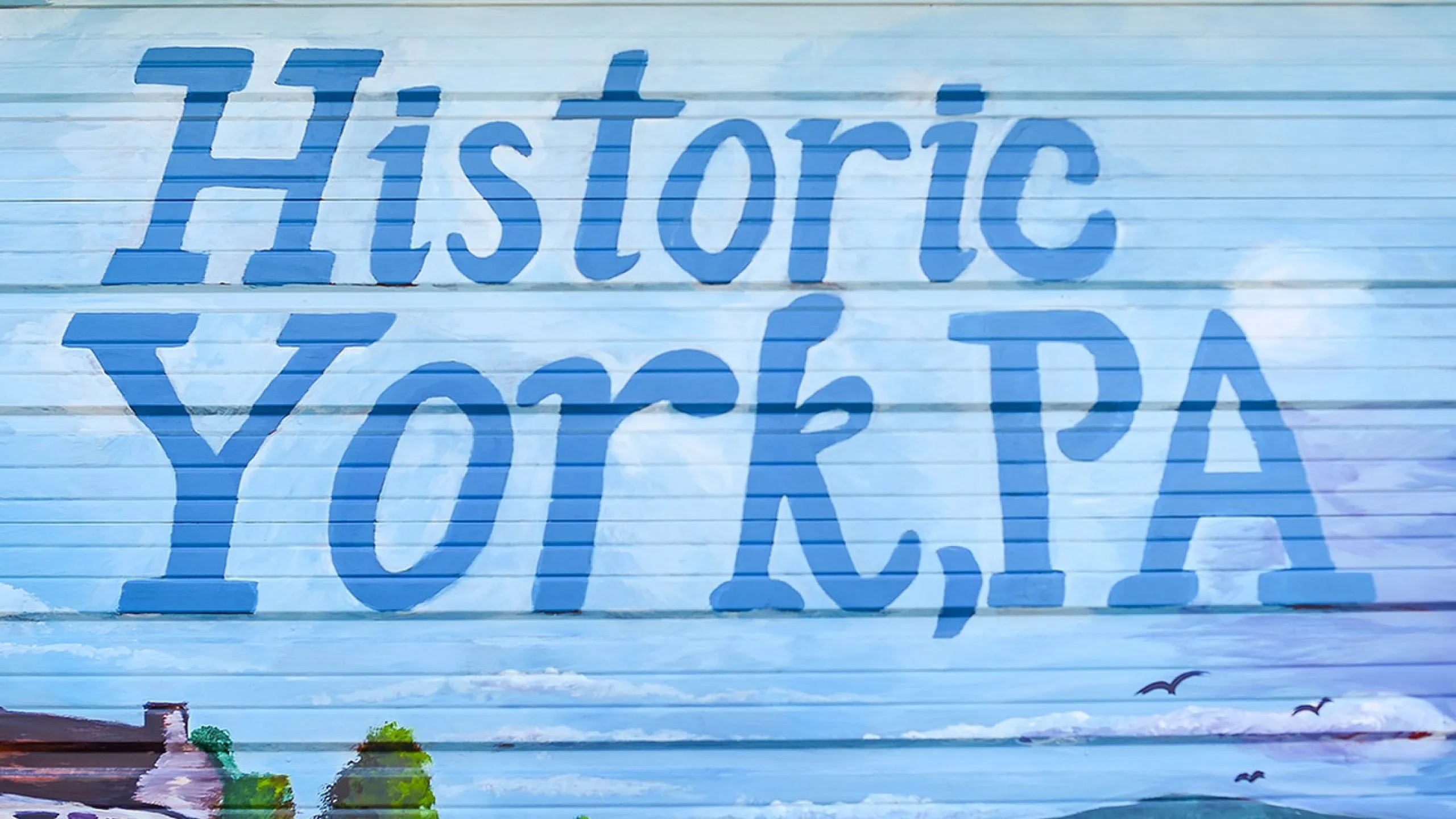 Charming mural of Historic York, PA, featuring picturesque landscapes with lush greenery and elegant architecture.