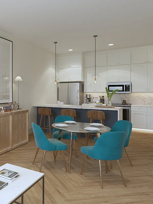 Modern open-concept living room with elegant decor and integrated kitchen, featuring chic teal dining chairs and a cozy gray sofa, bathed in natural light.