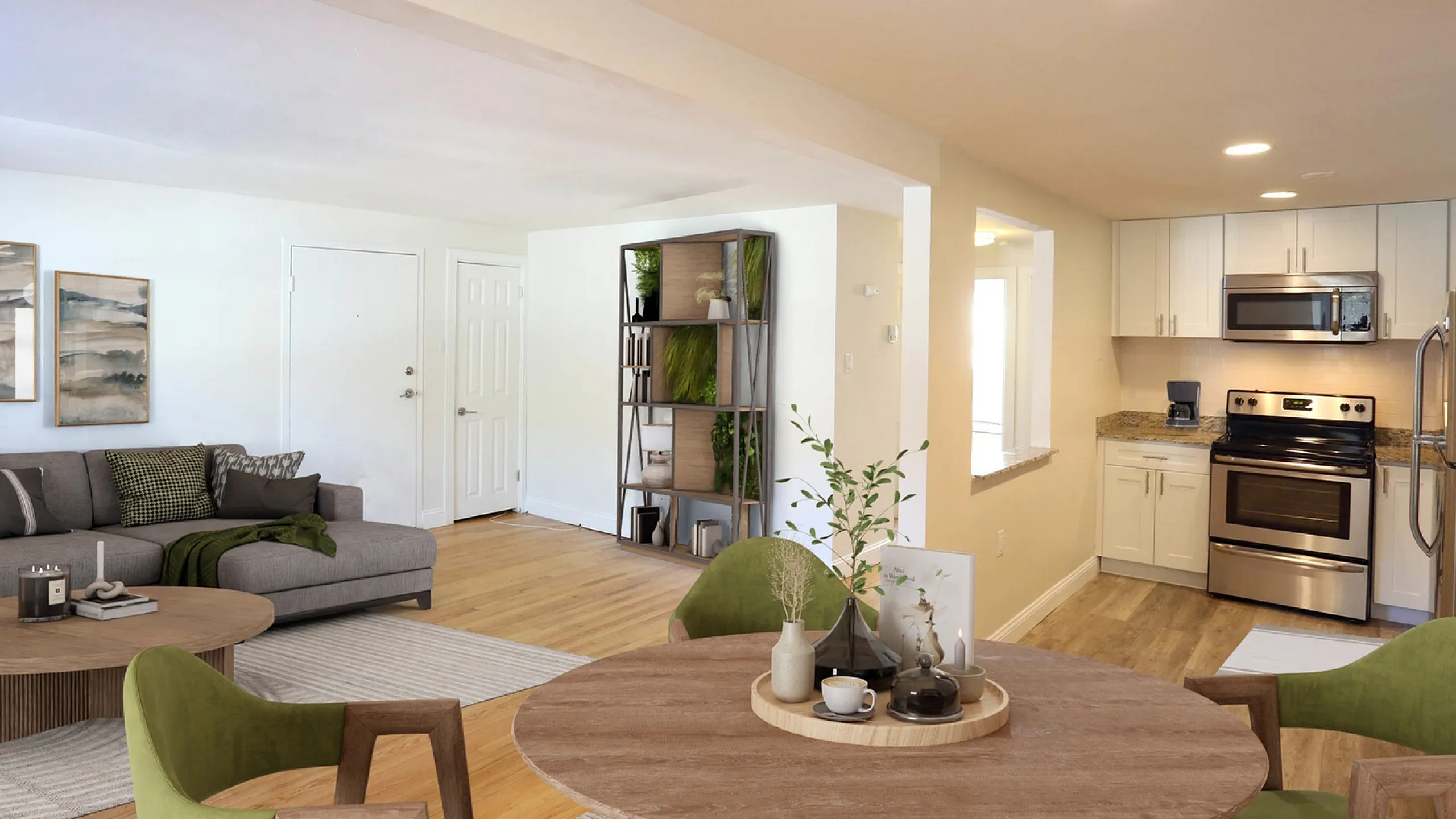 Inviting open-concept living space with chic kitchen, modern stainless steel appliances, and stylish dining area, perfect for entertaining.