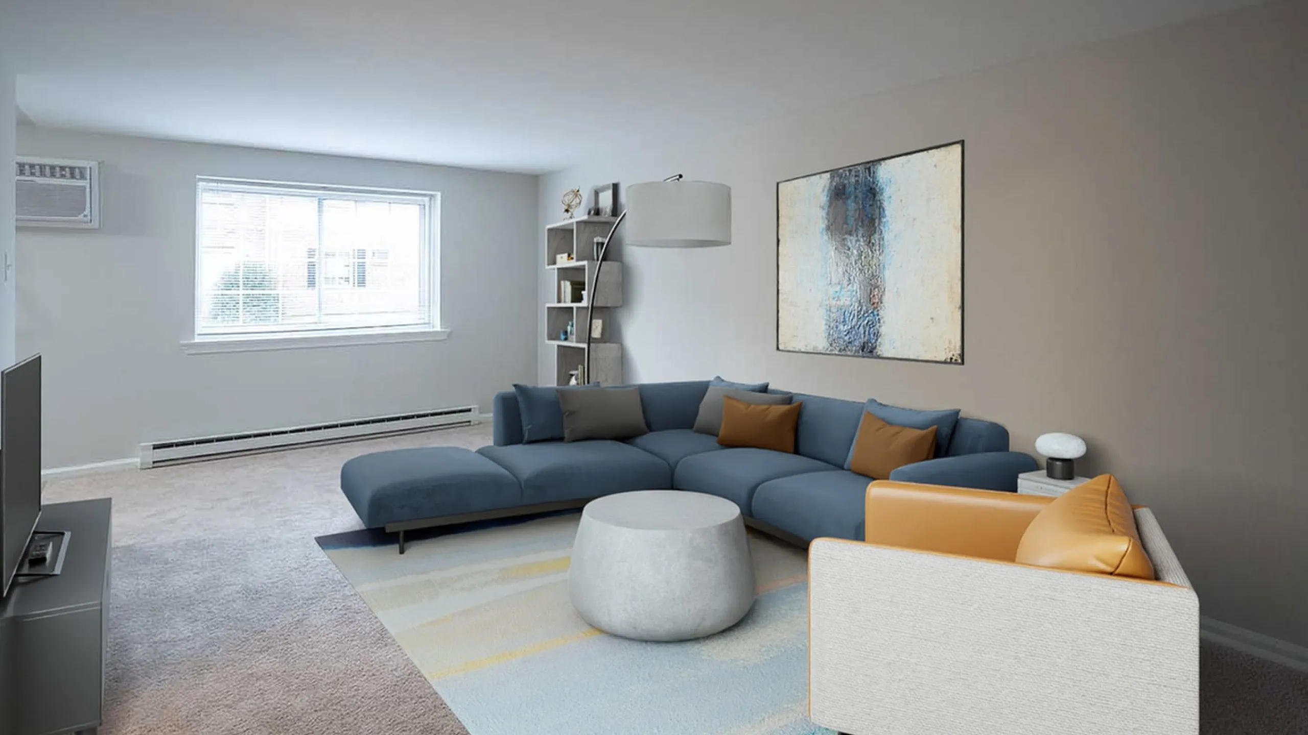 Contemporary living room with stylish blue sectional sofa, modern artwork, and ample natural light through large window.