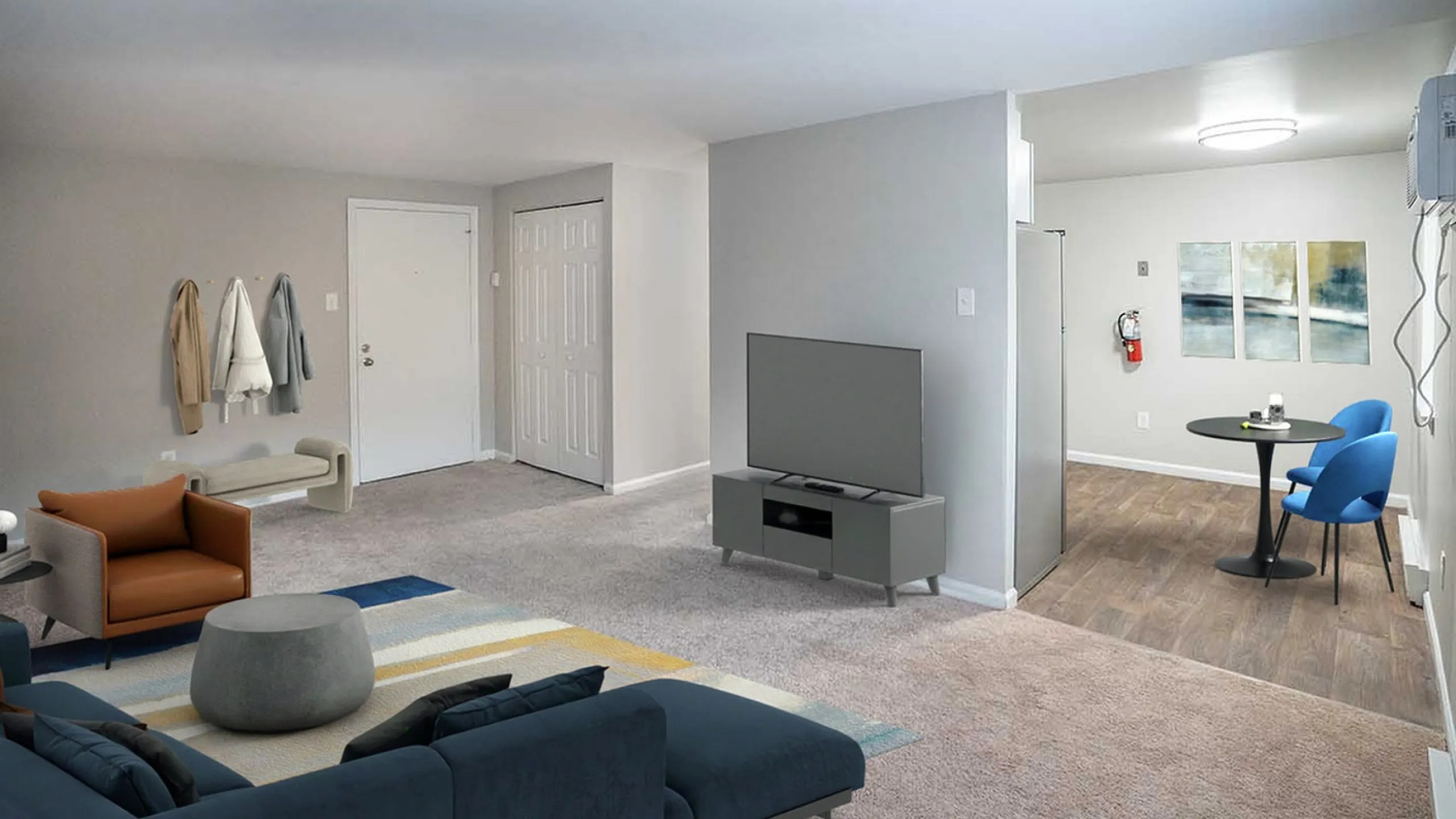 Modern living room with cozy seating, sleek TV setup, and an inviting dining nook featuring stylish blue chairs.