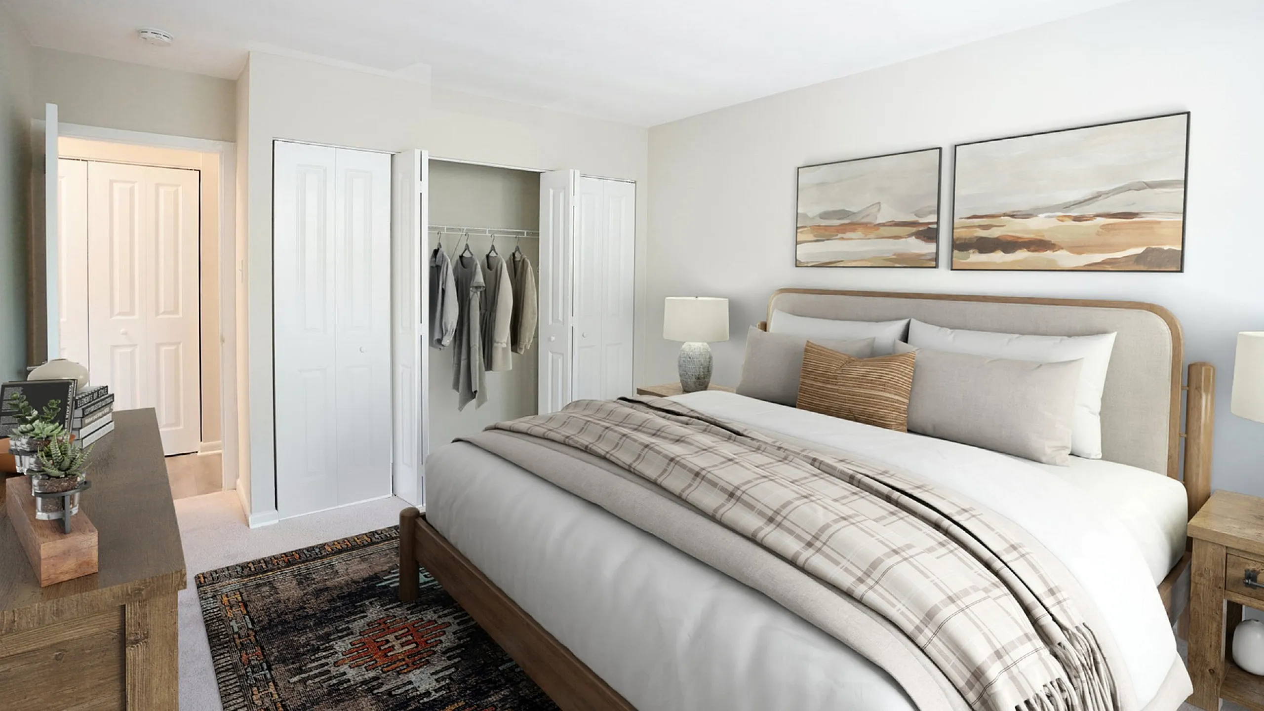 Cozy bedroom featuring a plush bed with soft linens, elegant decor, and spacious closet with neatly arranged clothes.