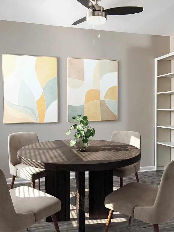 Modern dining area with a stylish round table, artistic wall decor, and bright natural lighting, seamlessly connecting to a sleek, contemporary kitchen.