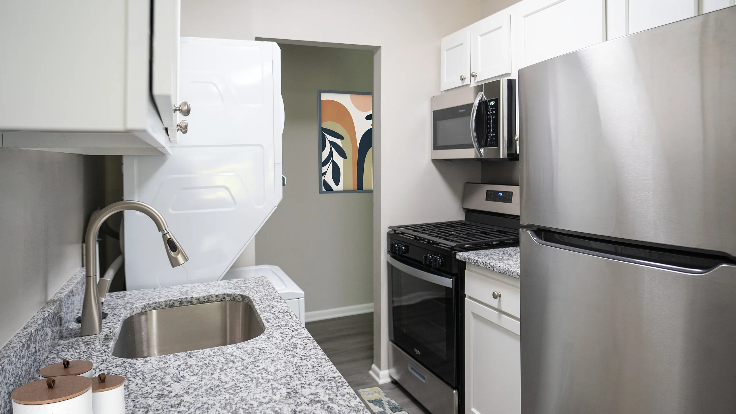 Modern kitchen featuring sleek stainless steel appliances, granite countertops, and elegant cabinetry.