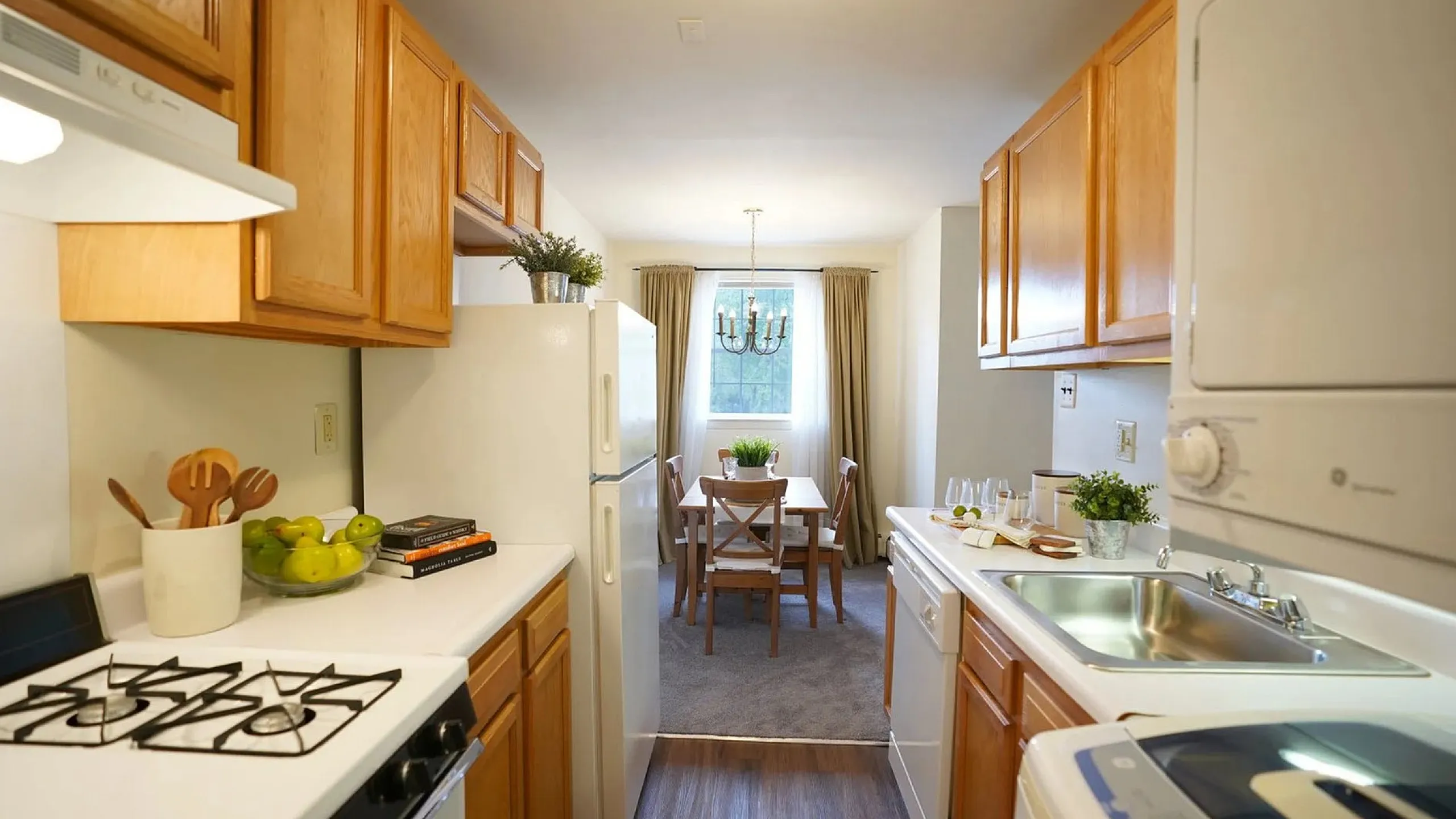Inviting kitchen-dining area with elegant wooden cabinets, modern appliances, and a cozy dining space drenched in natural light.