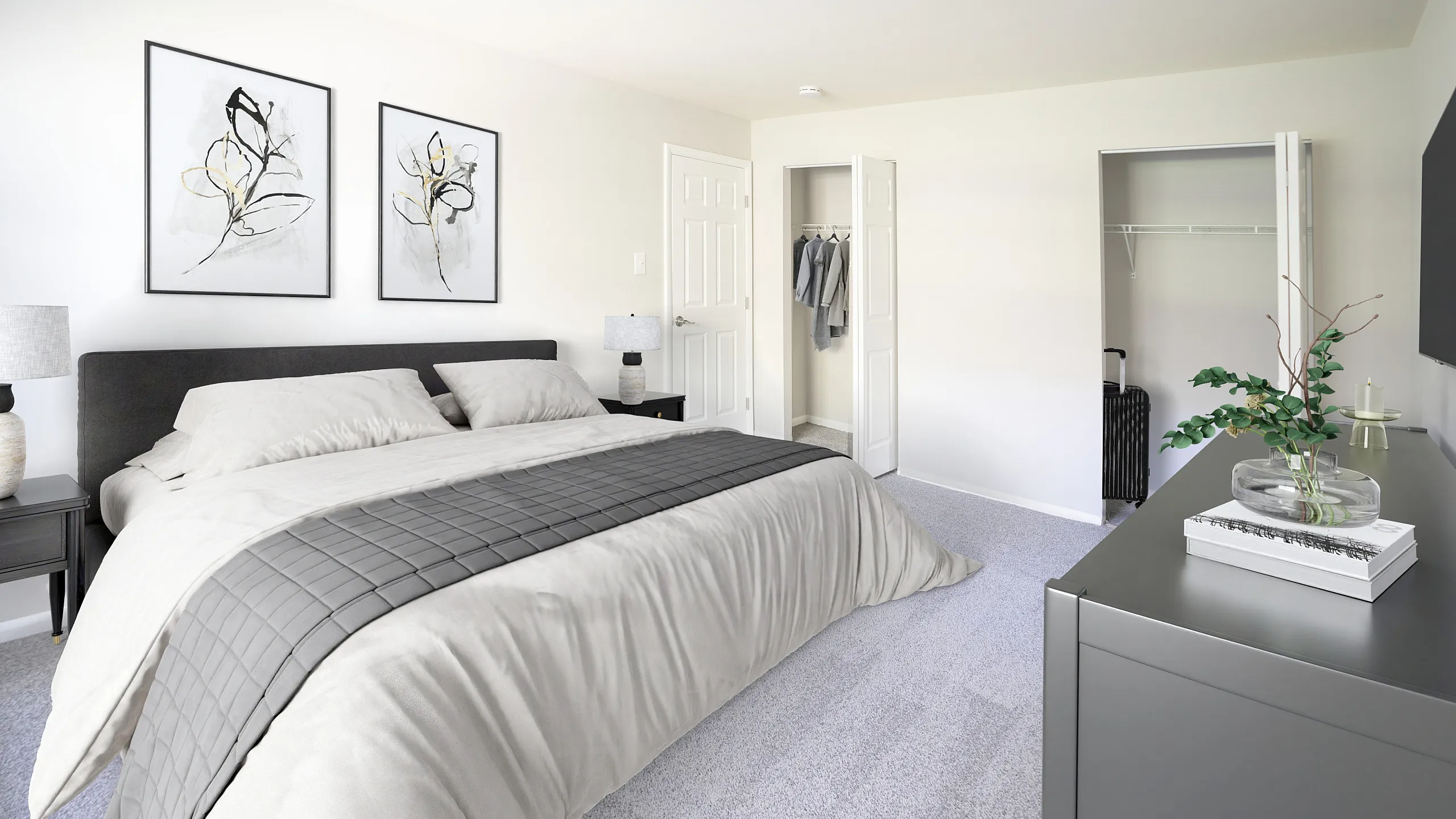 Elegant bedroom with modern decor, featuring a plush bed, minimalist artwork, and spacious closet, ideal for a cozy retreat.