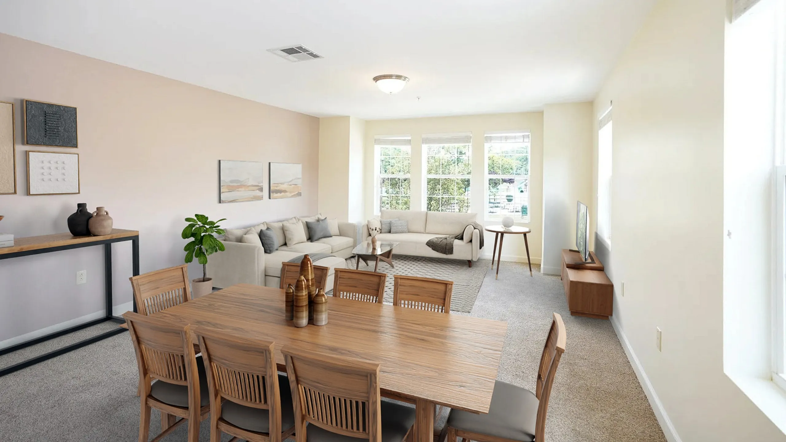 Bright and inviting open-plan living room featuring plush sofas, a modern dining area, and large windows for abundant natural light.