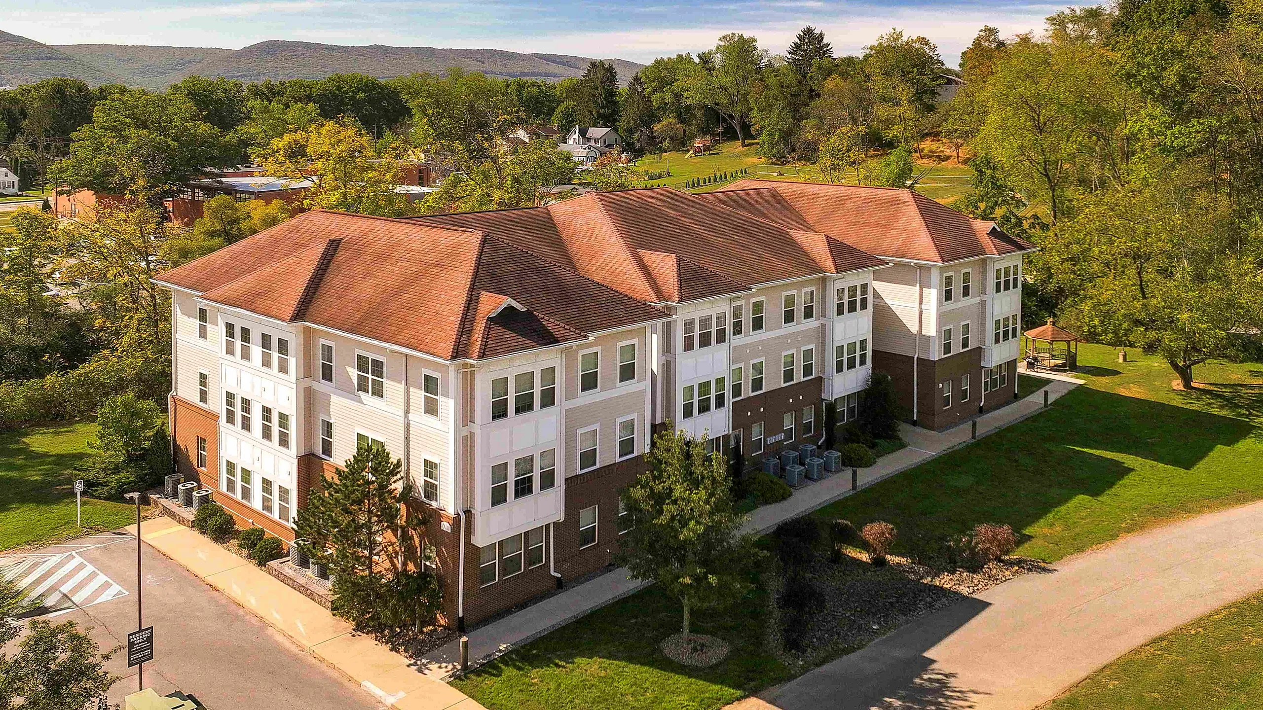 Charming apartment complex surrounded by lush greenery and scenic views, offering a peaceful community setting with modern amenities.