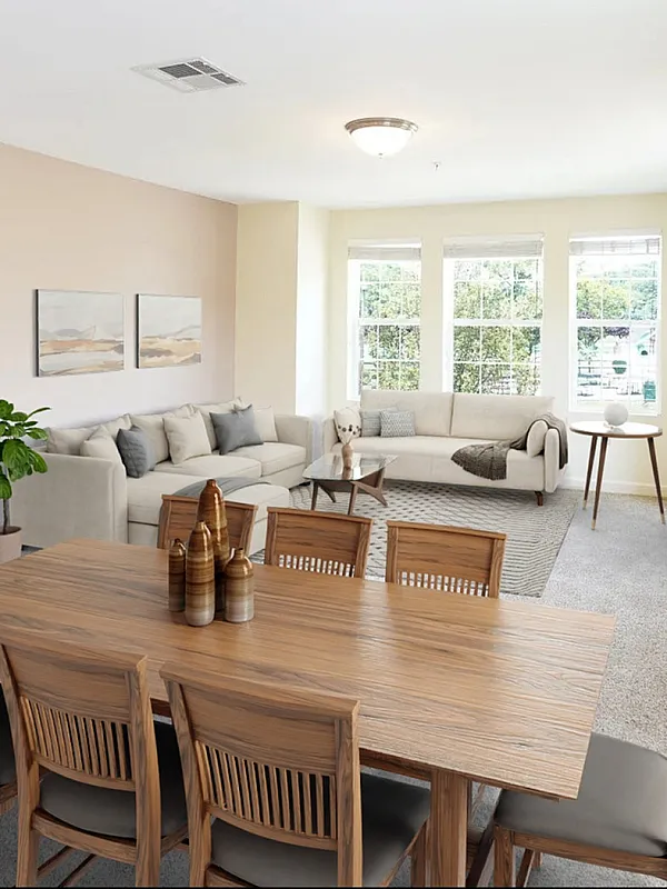Bright, airy living and dining area featuring elegant wooden furniture, cozy seating, and large windows for abundant natural light.