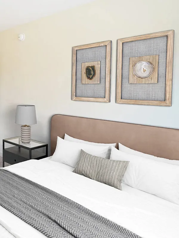 Chic bedroom with modern decor, featuring a cozy bed, stylish framed art, and a spacious closet for ultimate comfort.