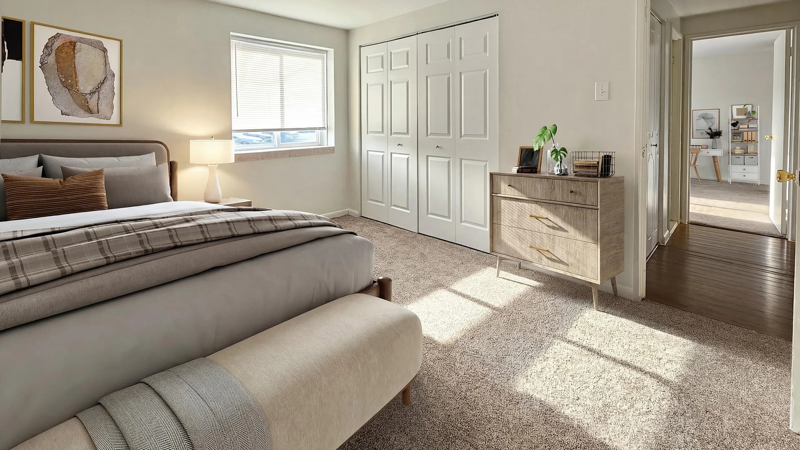 Bright and inviting bedroom with plush carpet, modern furnishings, and ample natural light streaming through the window.