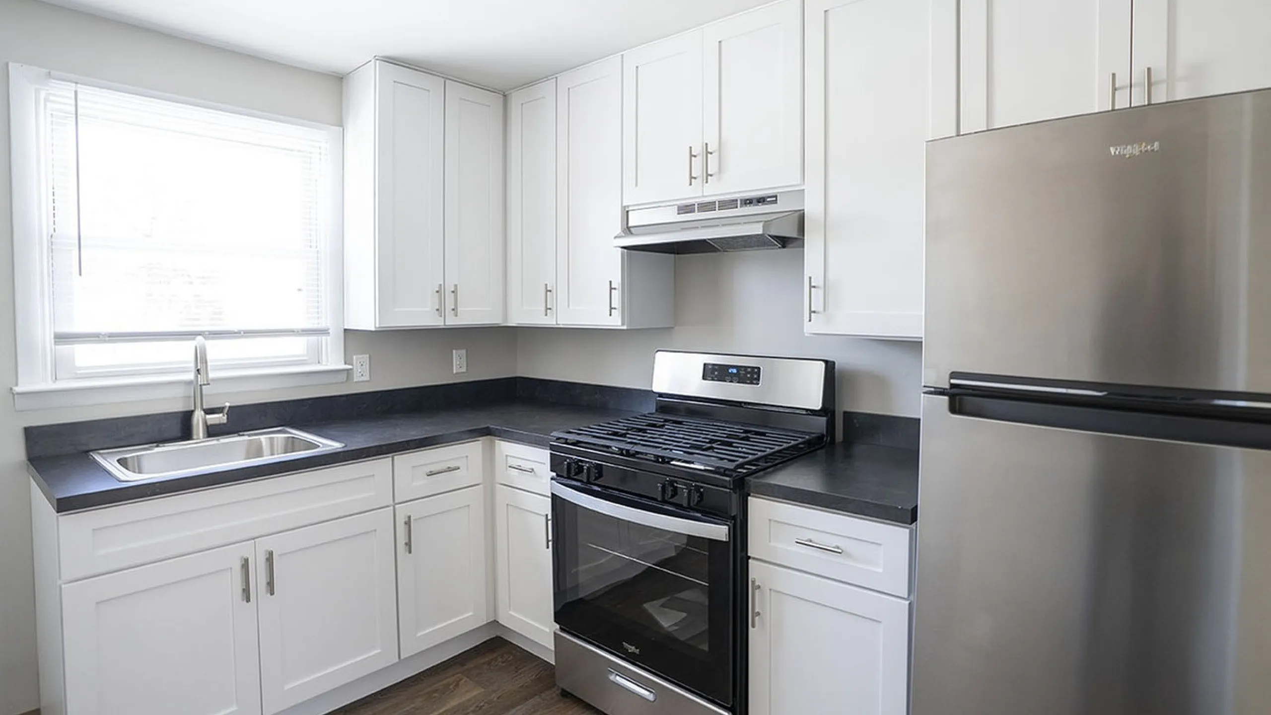 Bright and modern kitchen with sleek stainless steel appliances, elegant white cabinetry, and a spacious layout for efficient cooking.