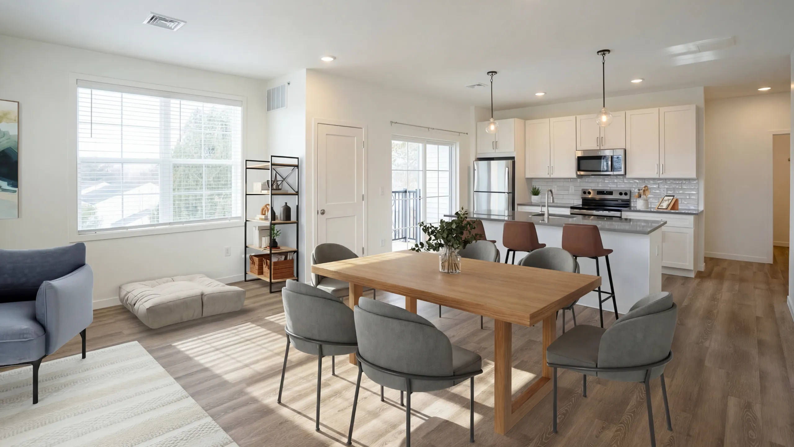 Modern open-concept dining area flowing into a sleek, fully-equipped kitchen with stainless steel appliances, abundant natural light, and stylish furnishings.
