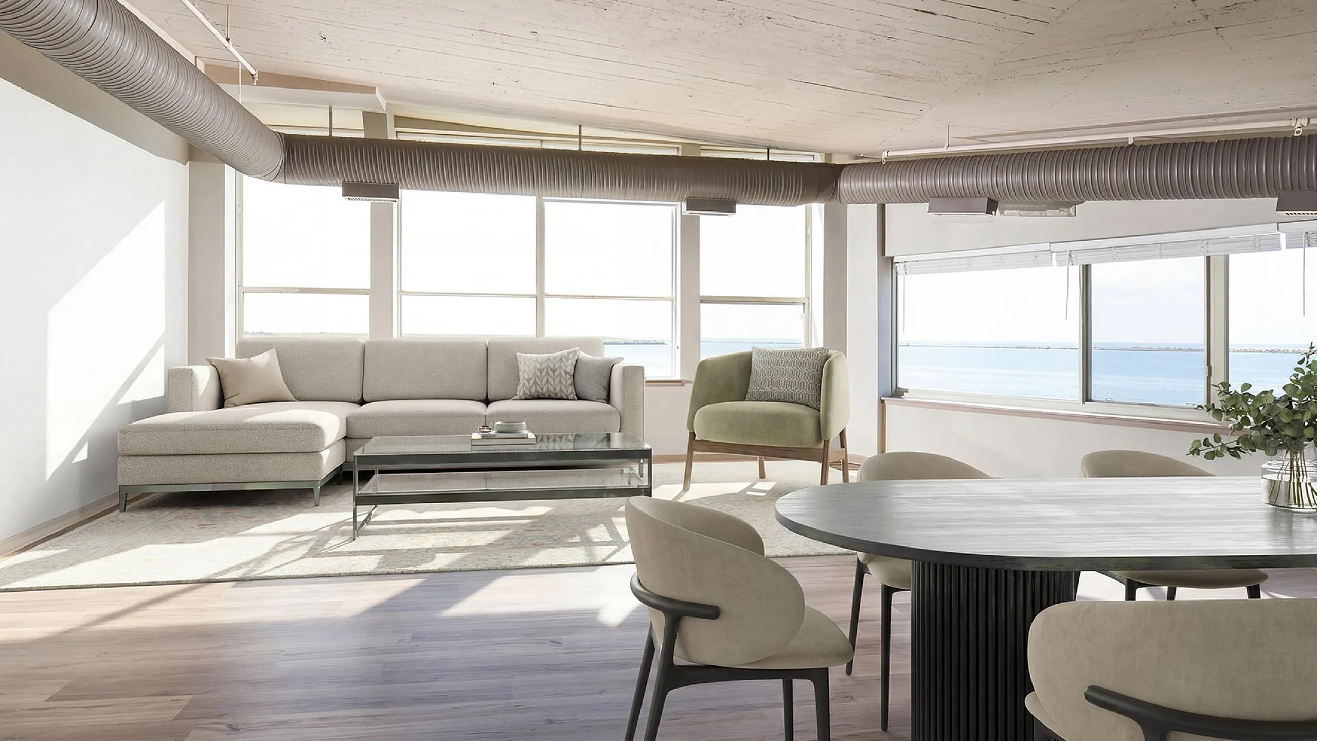 Modern living area with stylish furniture, large windows offering stunning ocean views, and an open-concept layout.