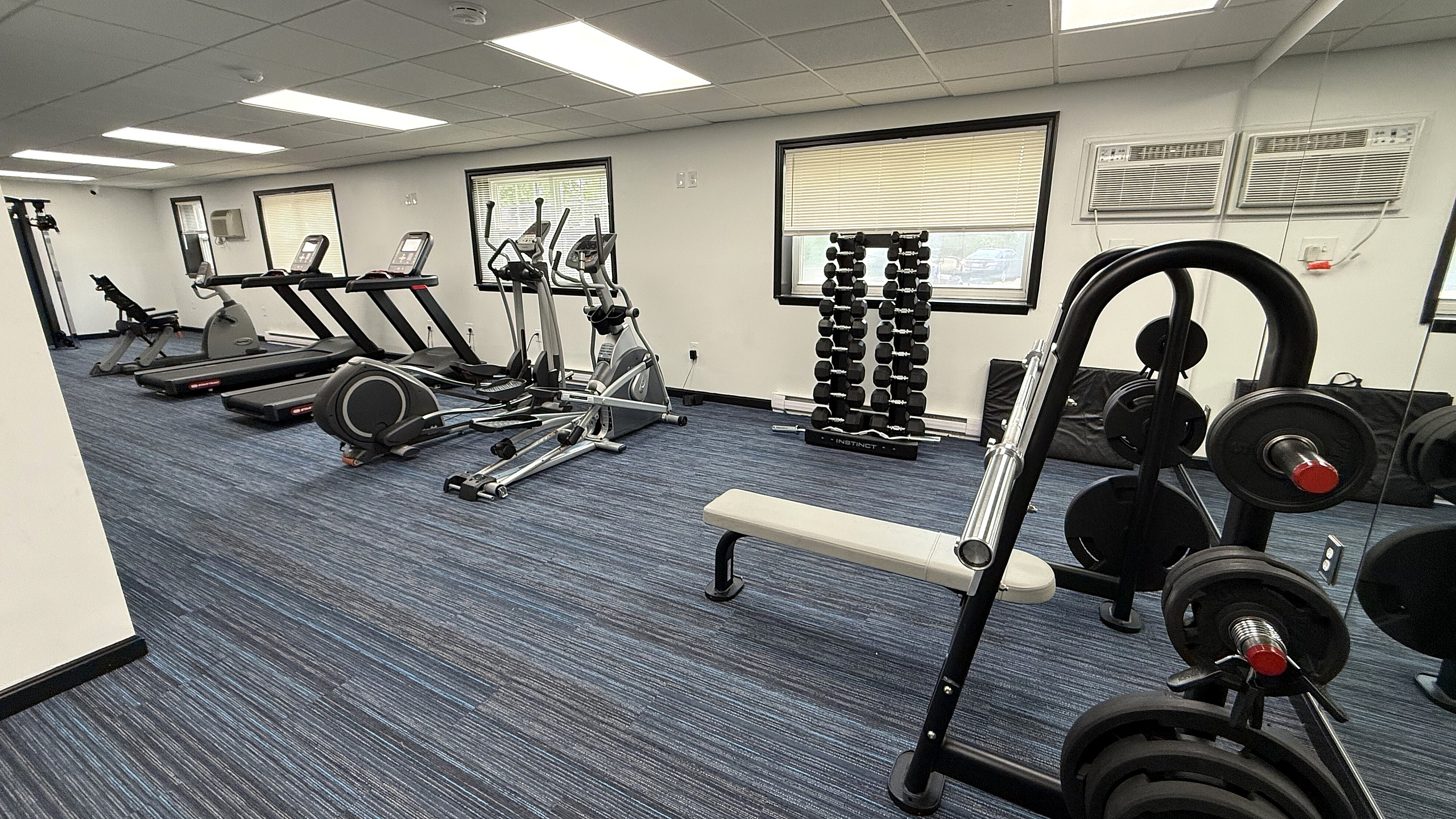 Spacious fitness center with state-of-the-art treadmills, ellipticals, and free weights, perfect for an invigorating workout.