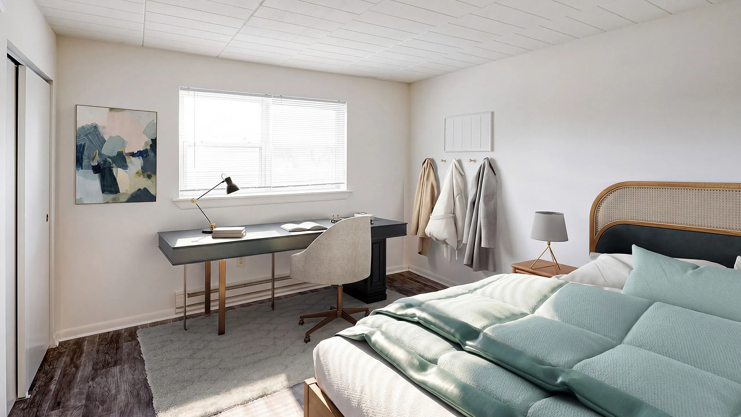 Bright and airy bedroom with modern desk setup, stylish wall art, cozy bedding, and ample natural light.