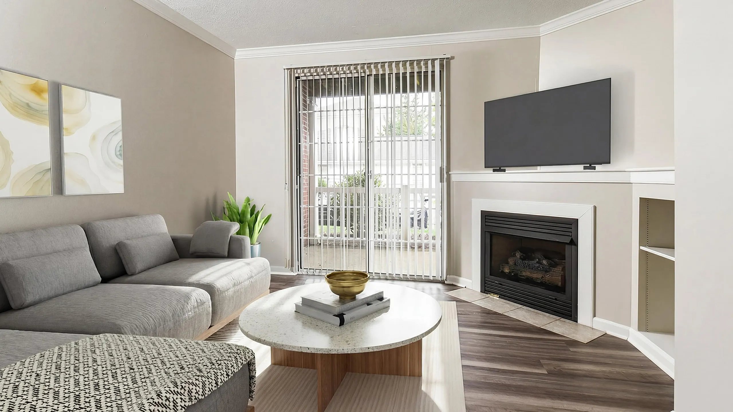 Bright and inviting living room with modern gray sectional, stylish coffee table, and elegant fireplace, perfect for cozy gatherings.