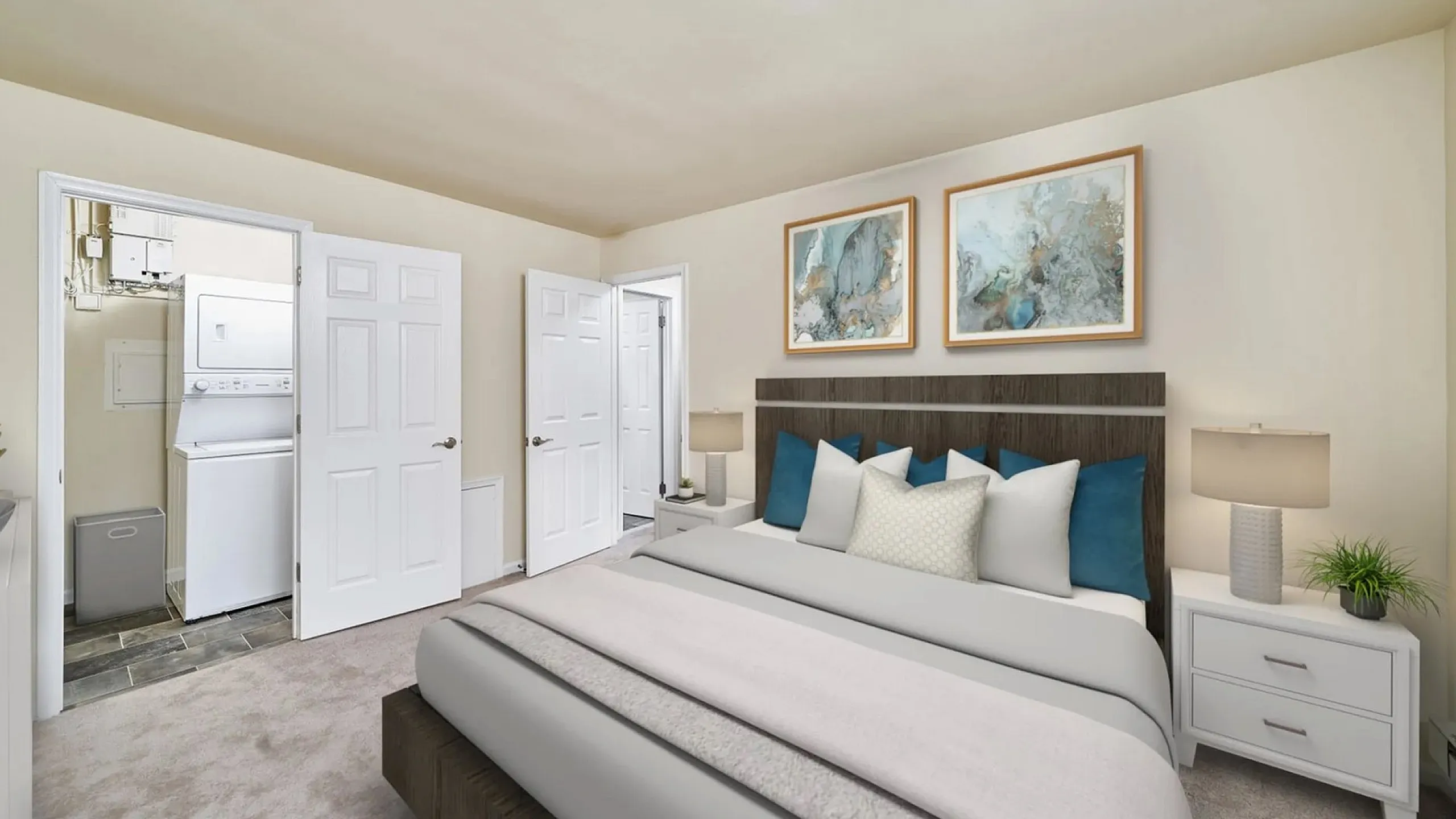 Elegant bedroom with modern decor, featuring a cozy bed, chic artwork, and an ensuite laundry area.