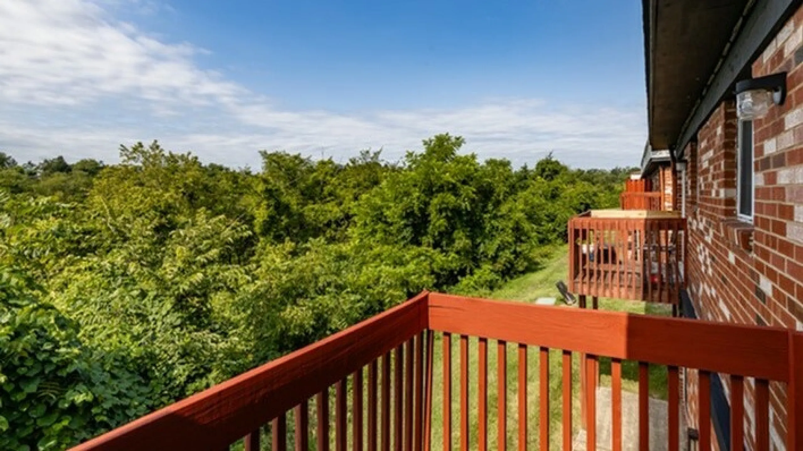 Charming balcony view showcasing lush green landscape, perfect for nature lovers and outdoor enthusiasts.