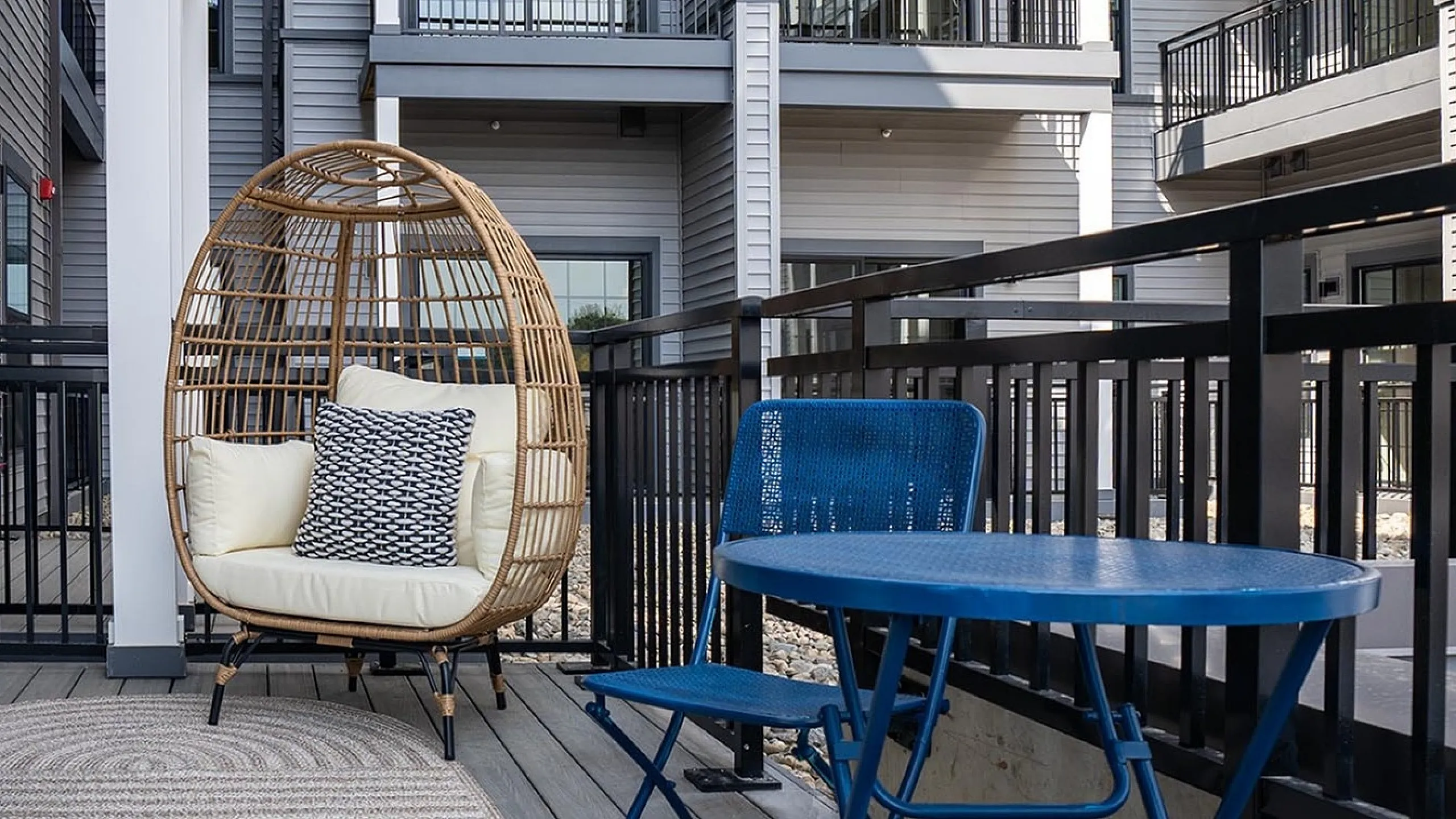 Modern apartment exterior with stylish balconies featuring cozy outdoor seating and vibrant furniture, perfect for relaxation and entertainment.