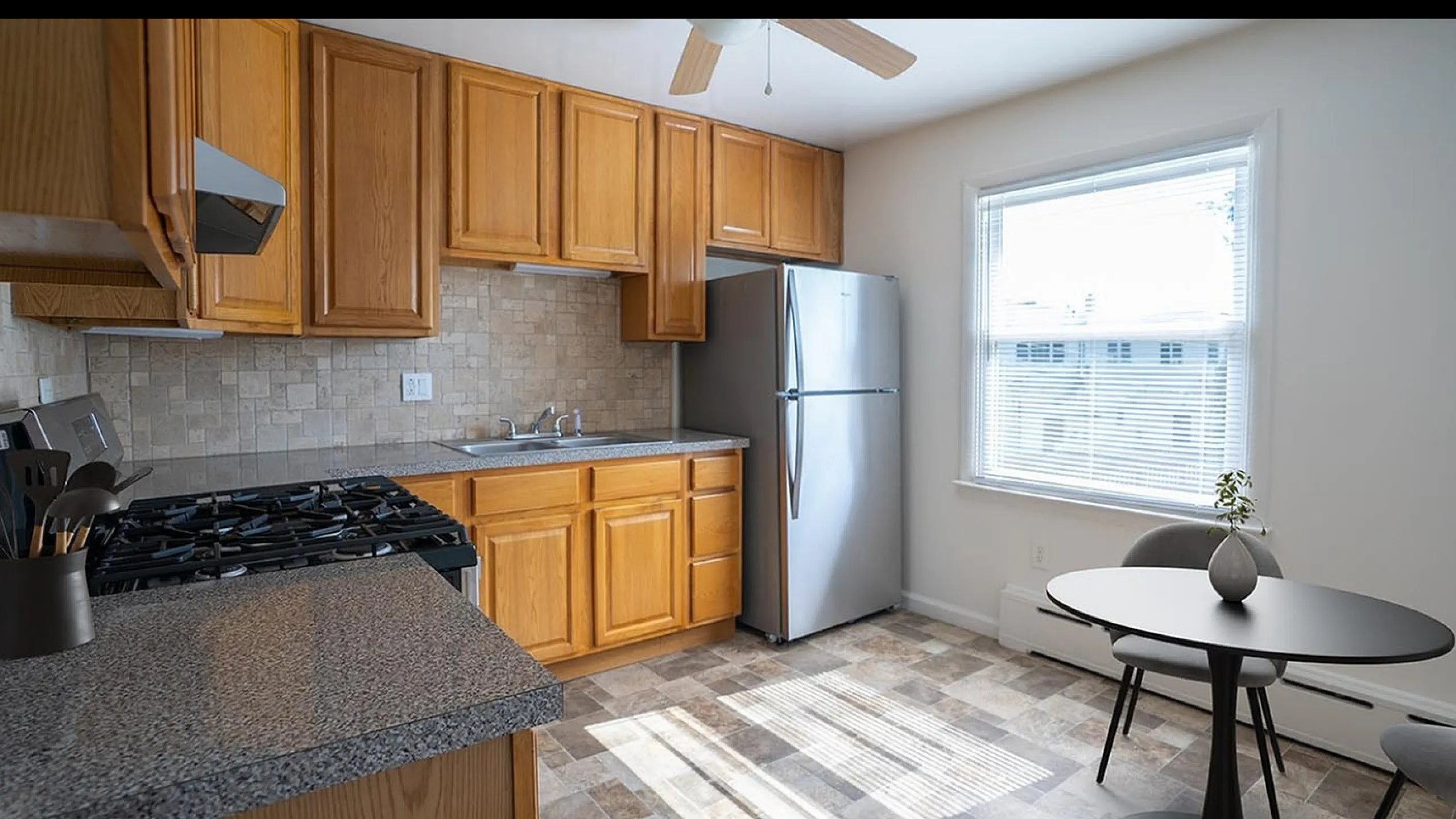 Bright and inviting kitchen with modern appliances, sleek countertops, and cozy dining area, perfect for culinary creativity.