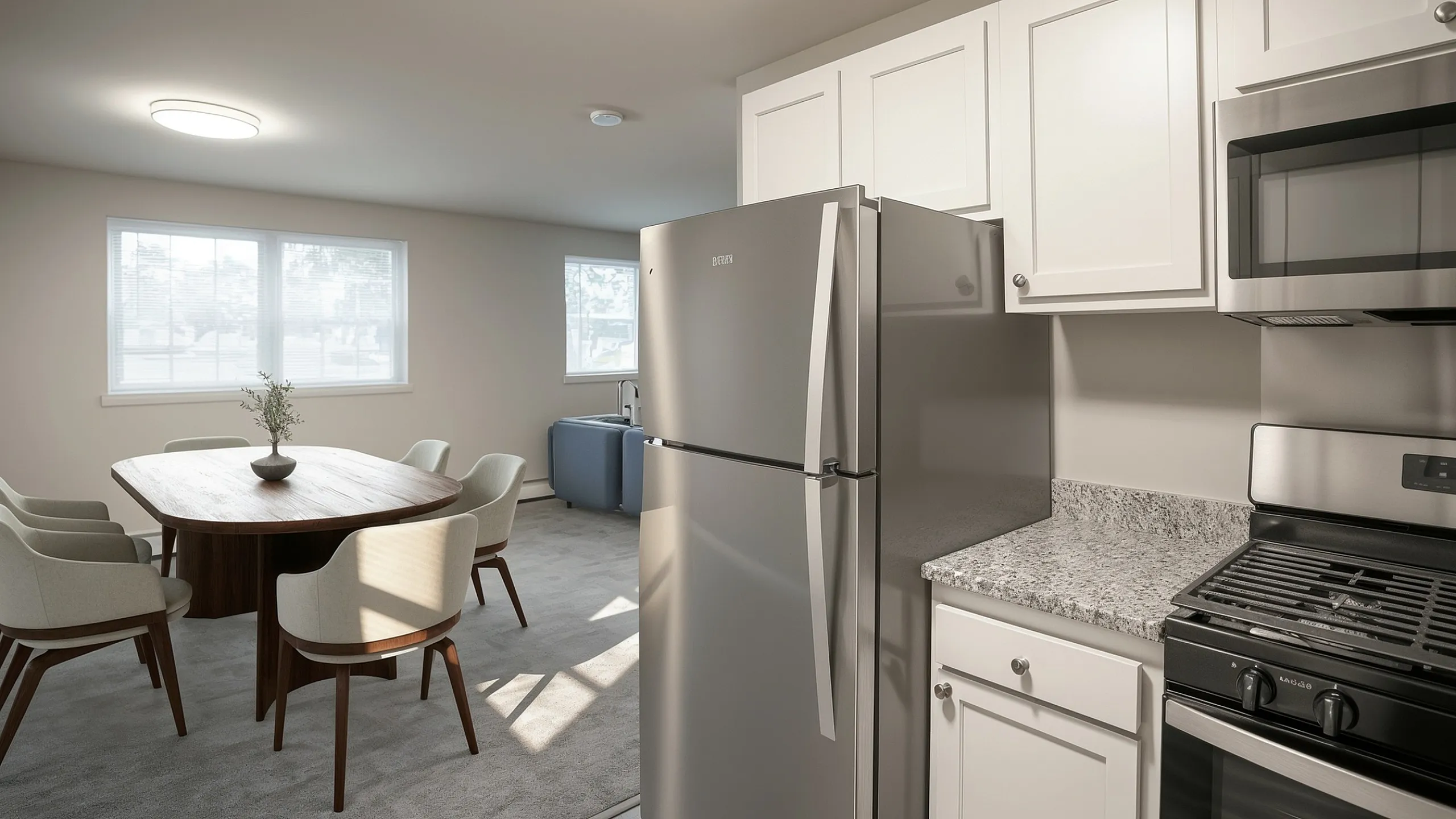 Modern kitchen and dining area with sleek stainless steel appliances, elegant wooden dining table, and abundant natural light.