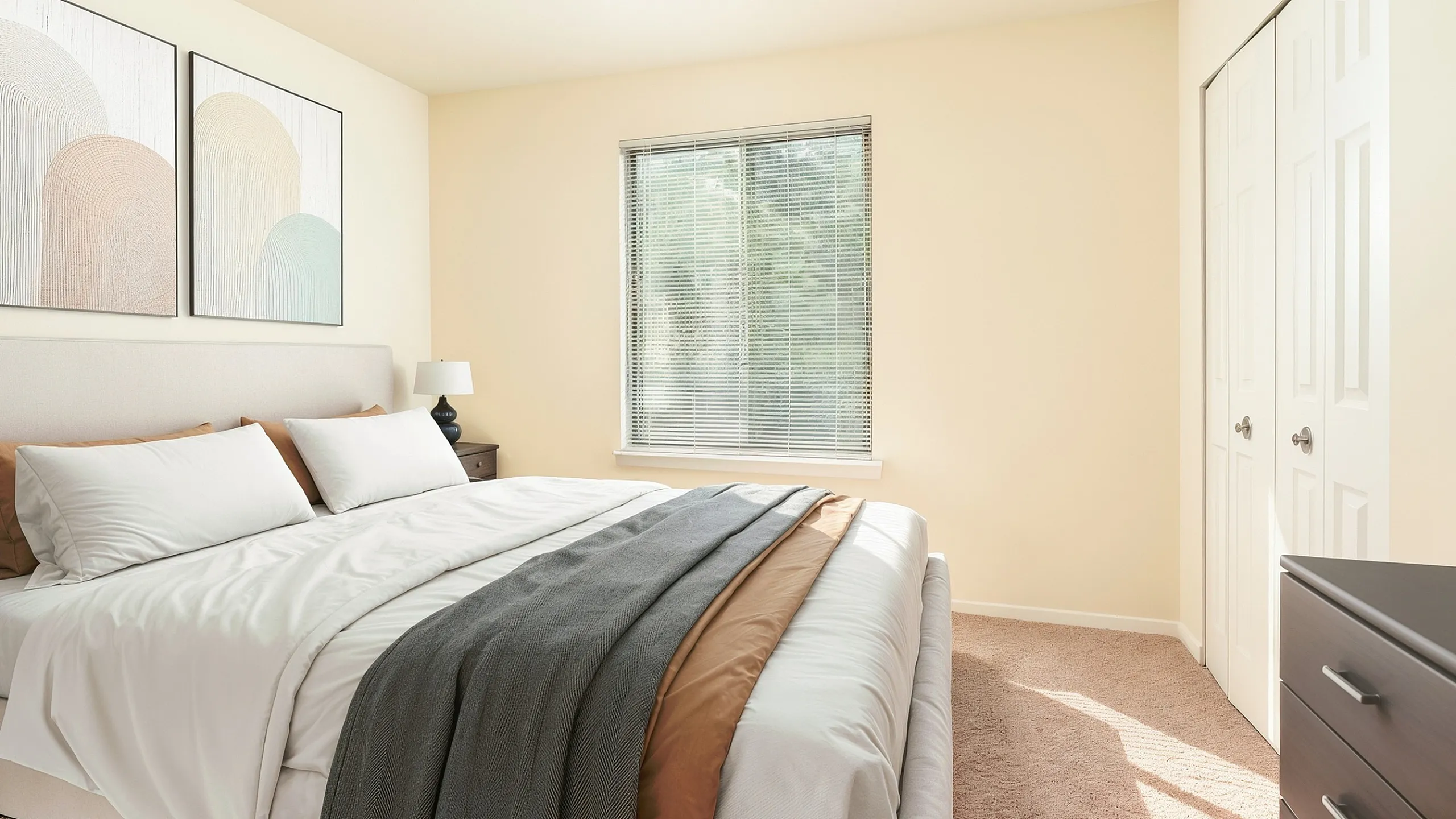Bright and welcoming bedroom featuring a king-sized bed with elegant linens, cozy carpet, large window with natural light, and stylish wall art.