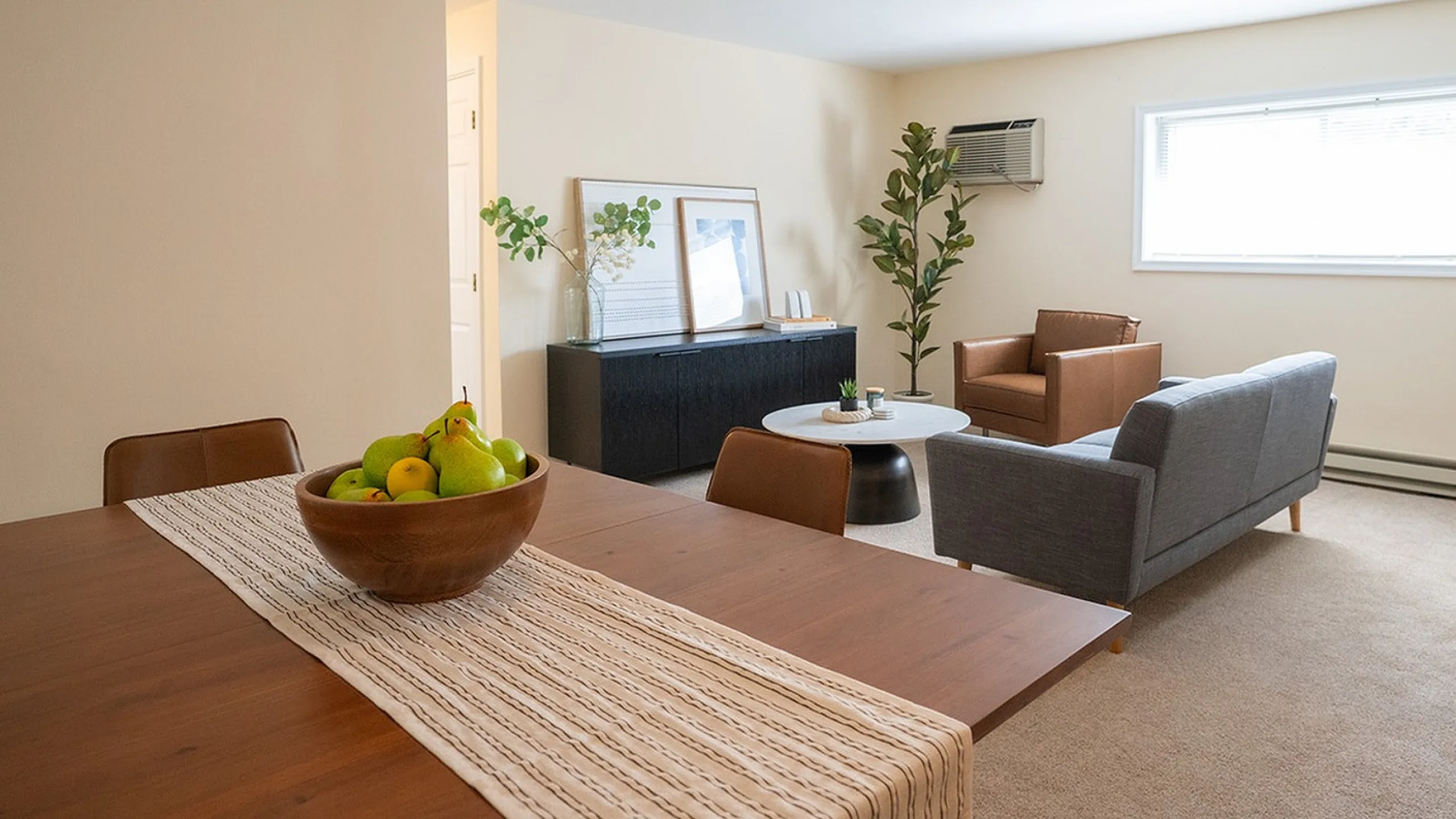 Inviting open-concept living room featuring cozy seating, stylish decor, and warm lighting, perfect for relaxation and entertaining.