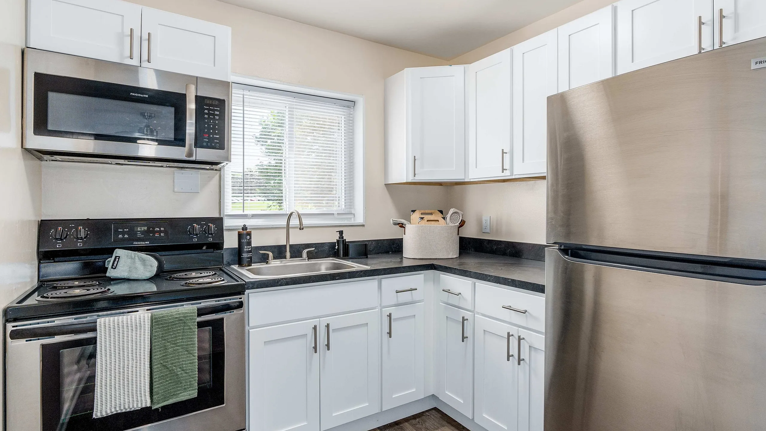 Modern kitchen with sleek stainless steel appliances, elegant cabinetry, and abundant natural light.