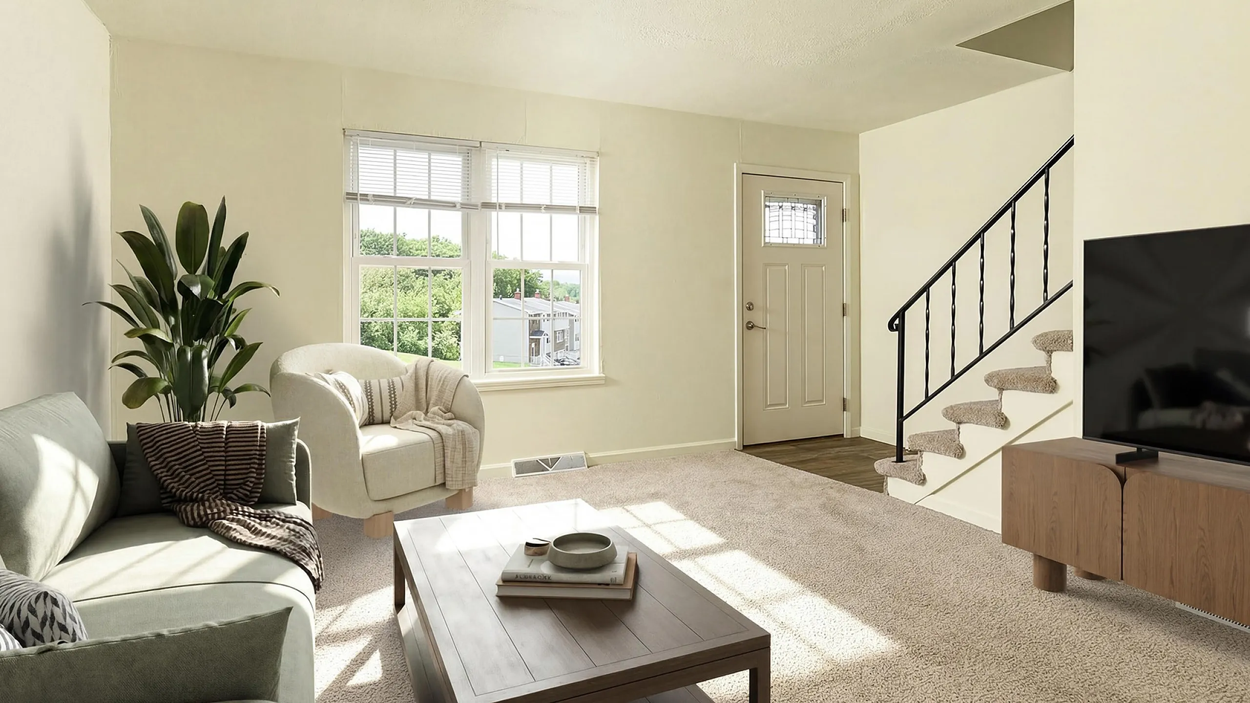 Inviting living room with abundant natural light, modern decor, plush carpet, and stylish staircase, perfect for relaxation.
