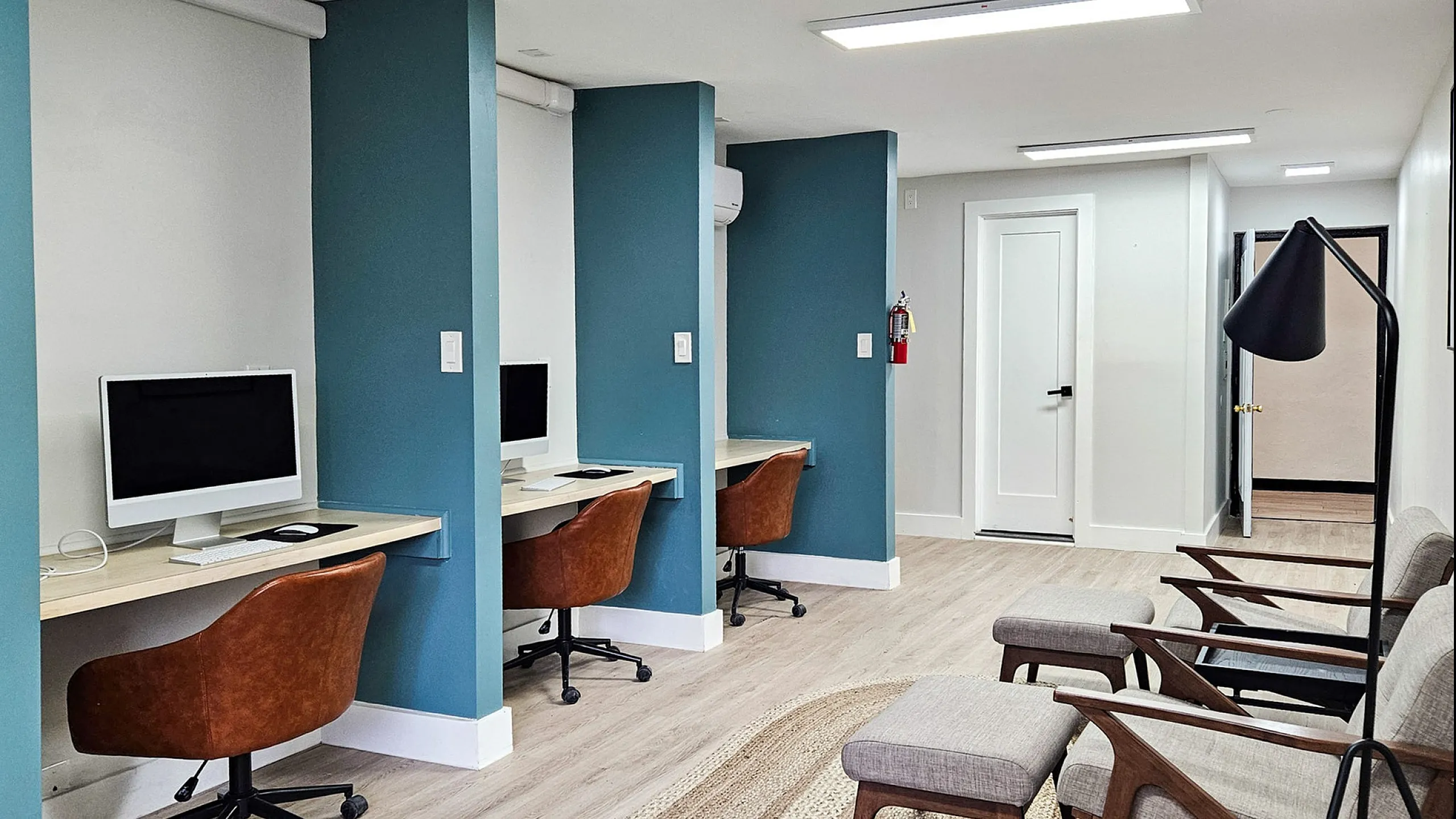 Modern workspace with sleek desks, ergonomic chairs, and ambient lighting, ideal for productivity and comfort.