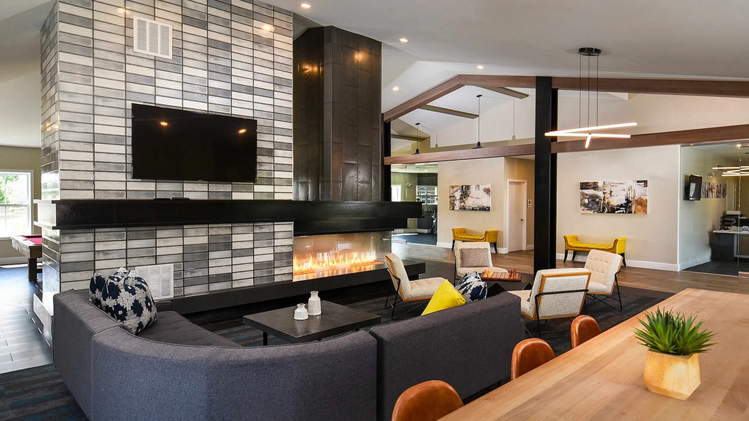 Luxurious open-concept living space with a modern fireplace and stylish seating area, perfect for relaxation and entertaining.