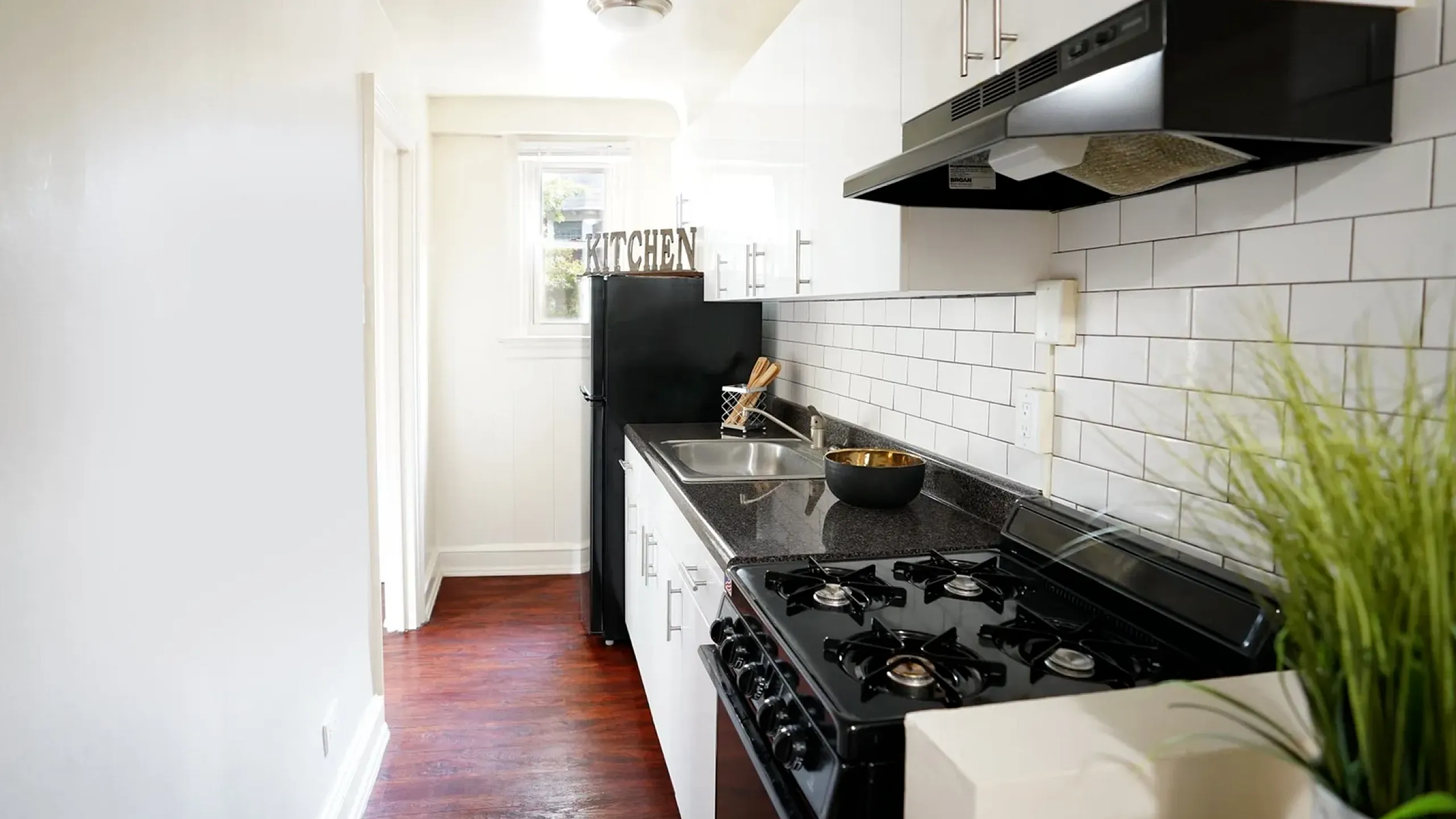 Charming kitchen with sleek countertops, modern appliances, and stylish white cabinetry, perfect for culinary enthusiasts.