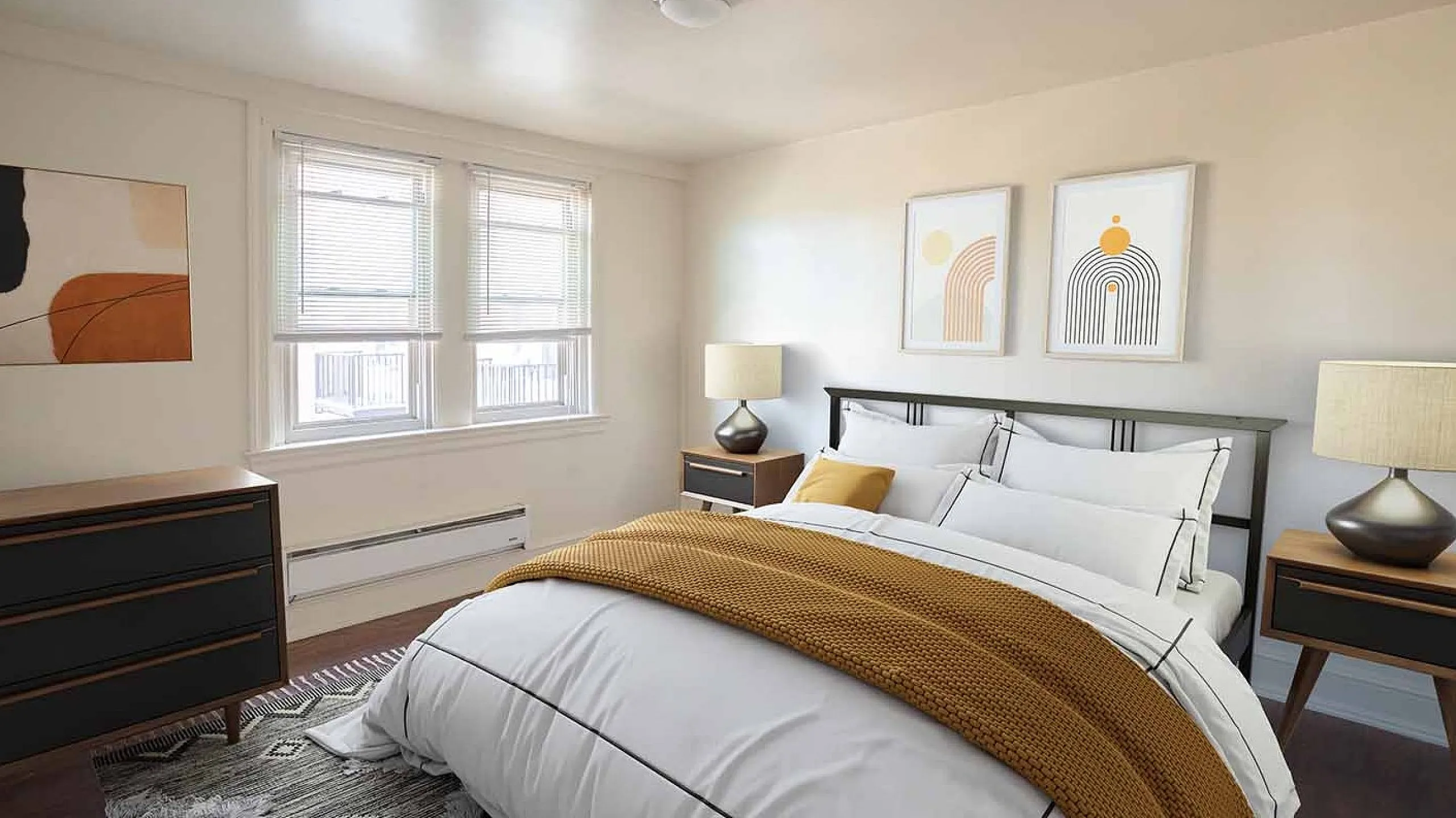 Bright and cozy bedroom with modern decor, featuring a stylish bed with a mustard throw, abstract wall art, and ample natural light from double windows.