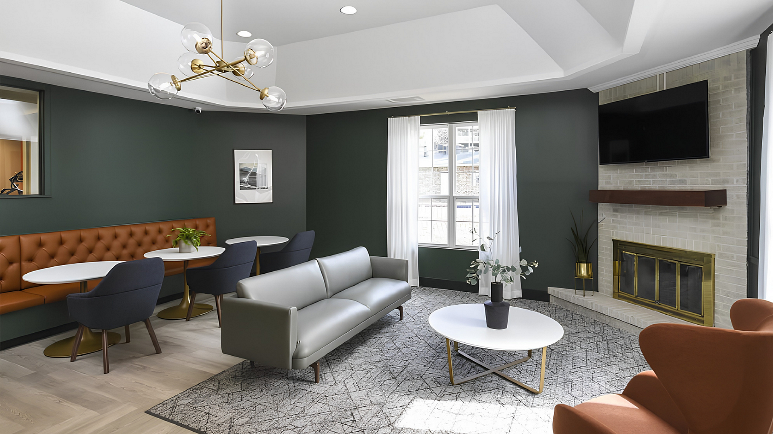 Chic living room with modern decor, featuring a cozy fireplace, stylish gray sofa, and elegant dining space with plush seating.