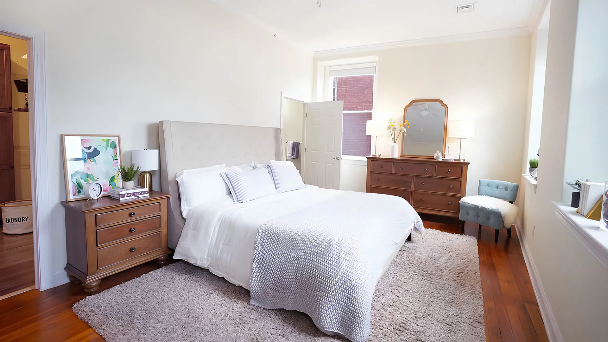 Bright and cozy bedroom with elegant furnishings, featuring a plush king-sized bed, soft lighting, and chic decor.