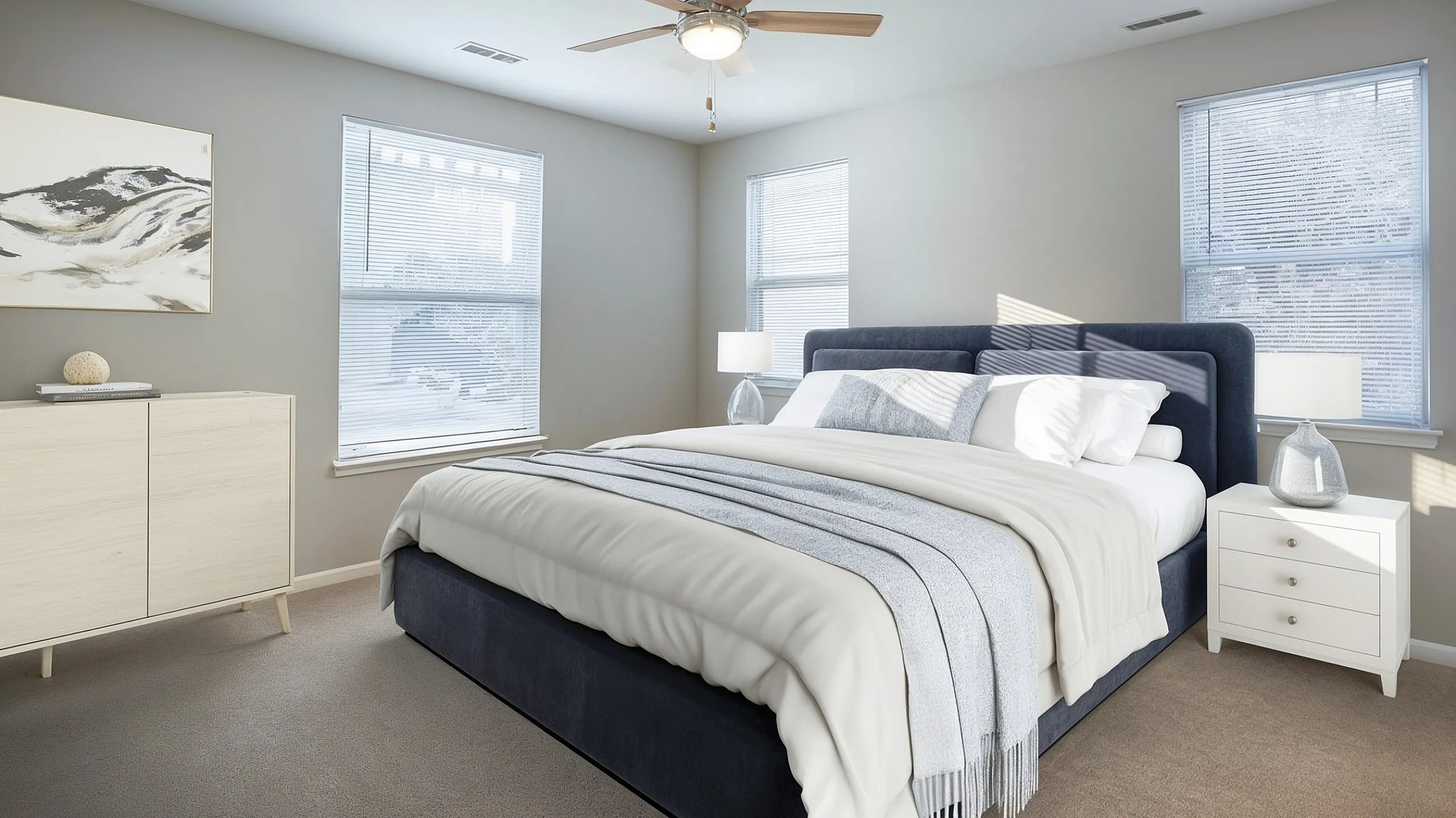 Cozy bedroom featuring a luxurious bed with elegant decor, modern ceiling fan, and abundant natural light through large windows.