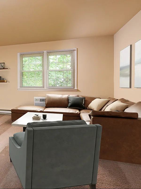 Inviting living room with abundant natural light, featuring a plush sectional sofa, sleek entertainment center, and tasteful wall decor.